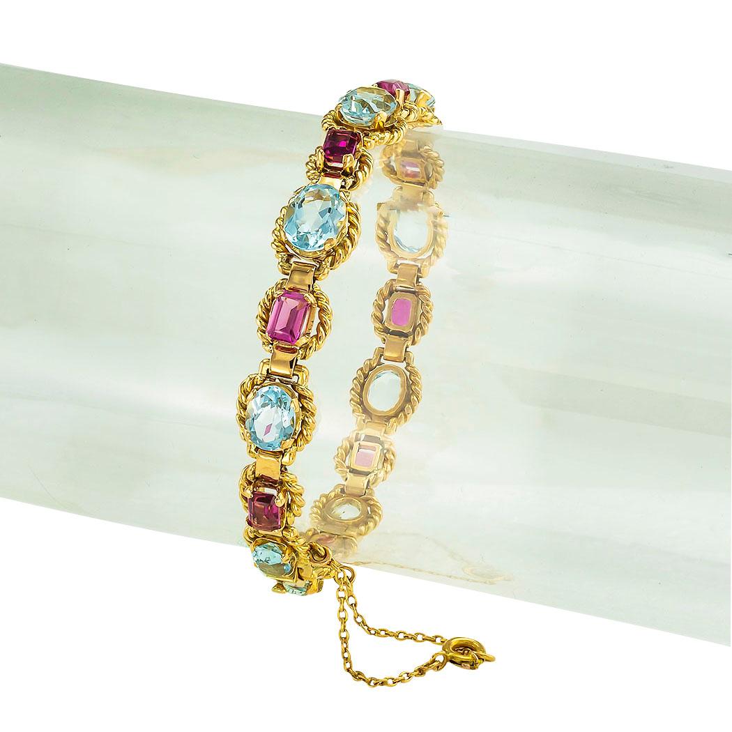 Retro aquamarine pink tourmaline and gold link bracelet circa 1950. *

ABOUT THIS ITEM:  #B1620. Scroll down for specifications.  Sturdy construction all around with an added, open and close, safety chain featuring a spring ring clasp.  The design