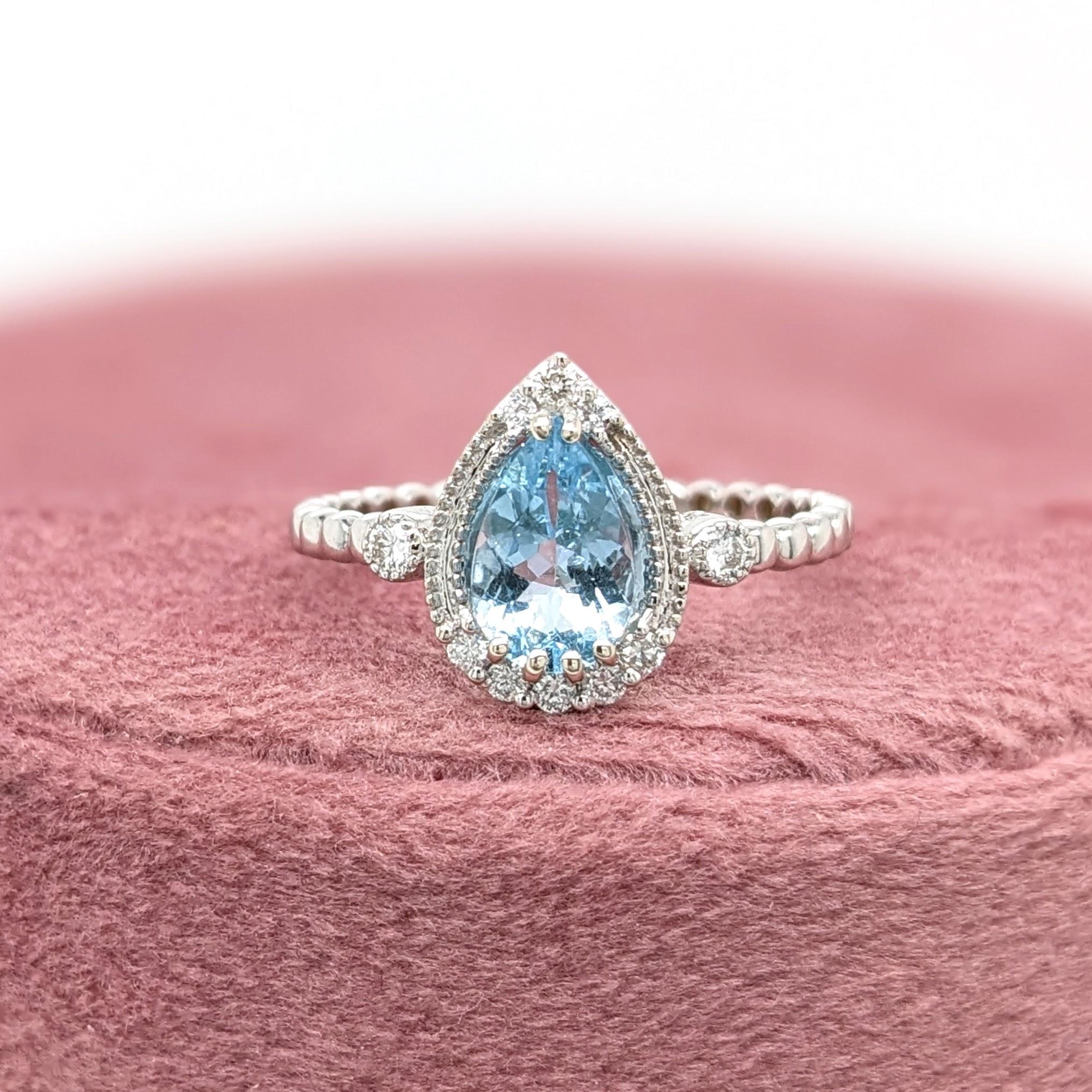This beautiful ring features a pear cut sparkling Aquamarine in 14k White Gold with a natural diamonds halo. A ring design perfect for an eye catching engagement or anniversary. This ring also makes a beautiful march birthstone ring for your loved