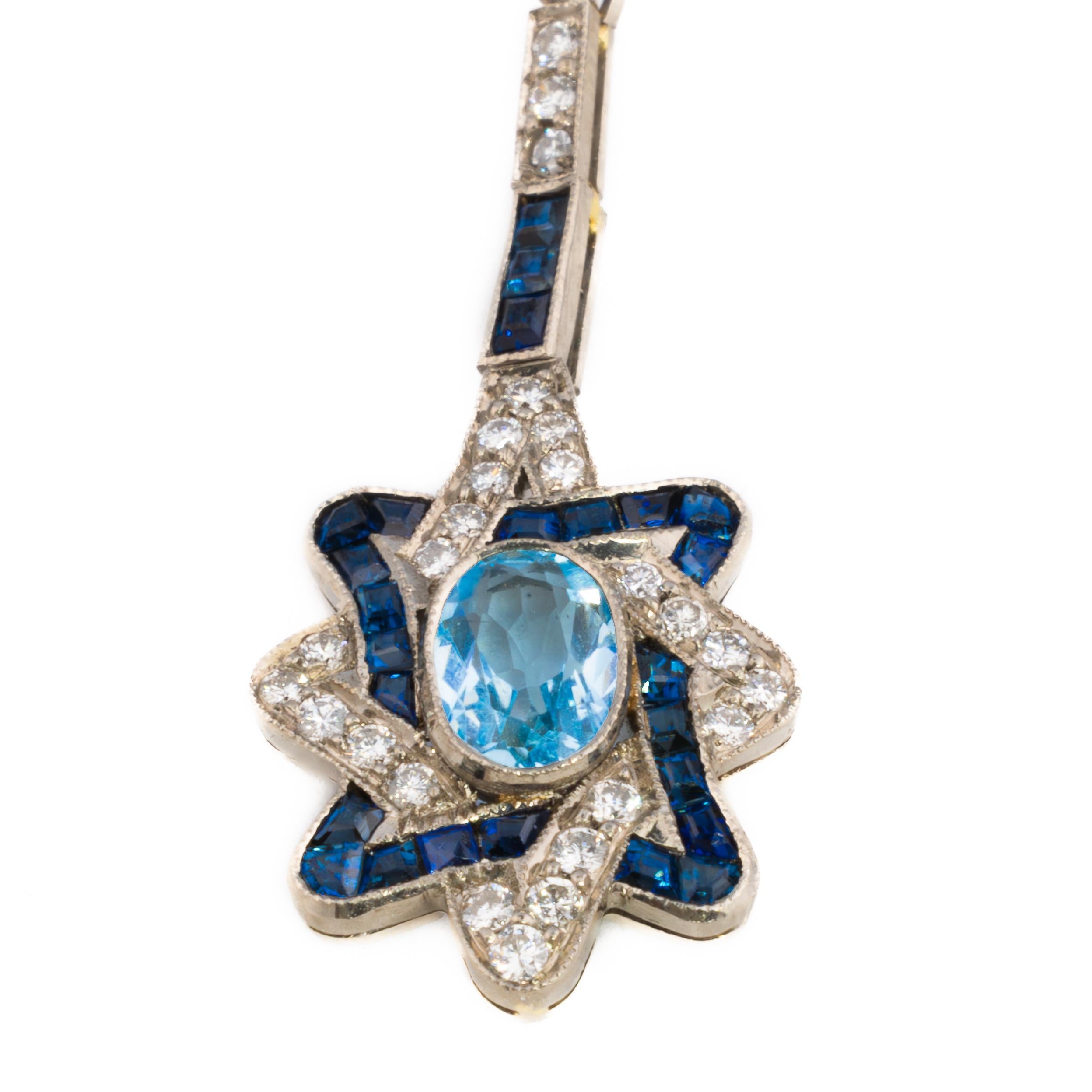 Aquamarine, Sapphire, and Diamond Star Drop Earrings

Description:
Playful yet refined, these earrings are designed as radiant starbursts crafted in 18K yellow gold. At the center of each earring lies an oval-cut aquamarine, totaling approximately