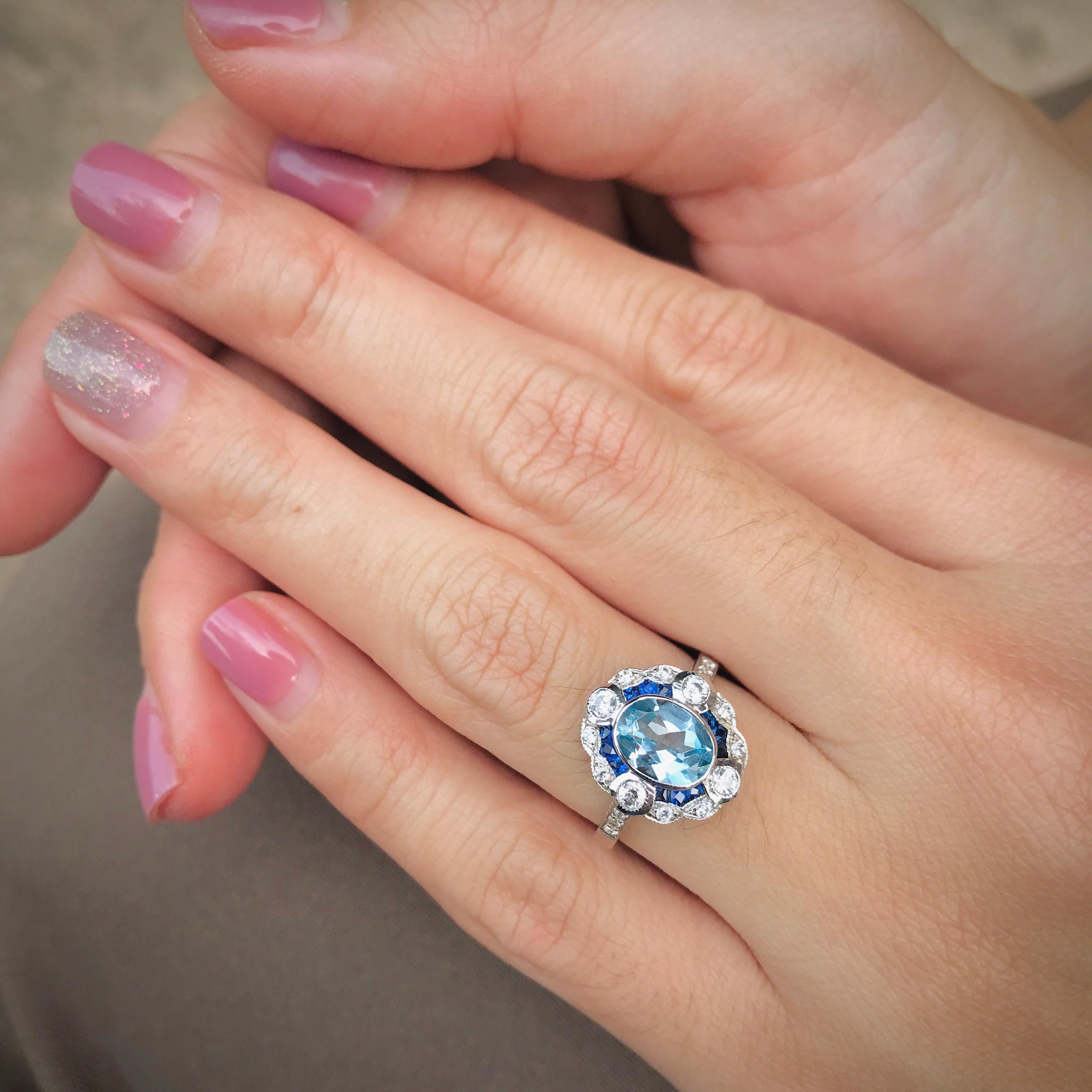 Introducing our stunning Aquamarine Sapphire Diamond Art Deco Style Engagement Ring, a unique expression of love and elegance. This exquisite piece features a captivating aquamarine at its heart, radiating a serene blue hue that symbolizes