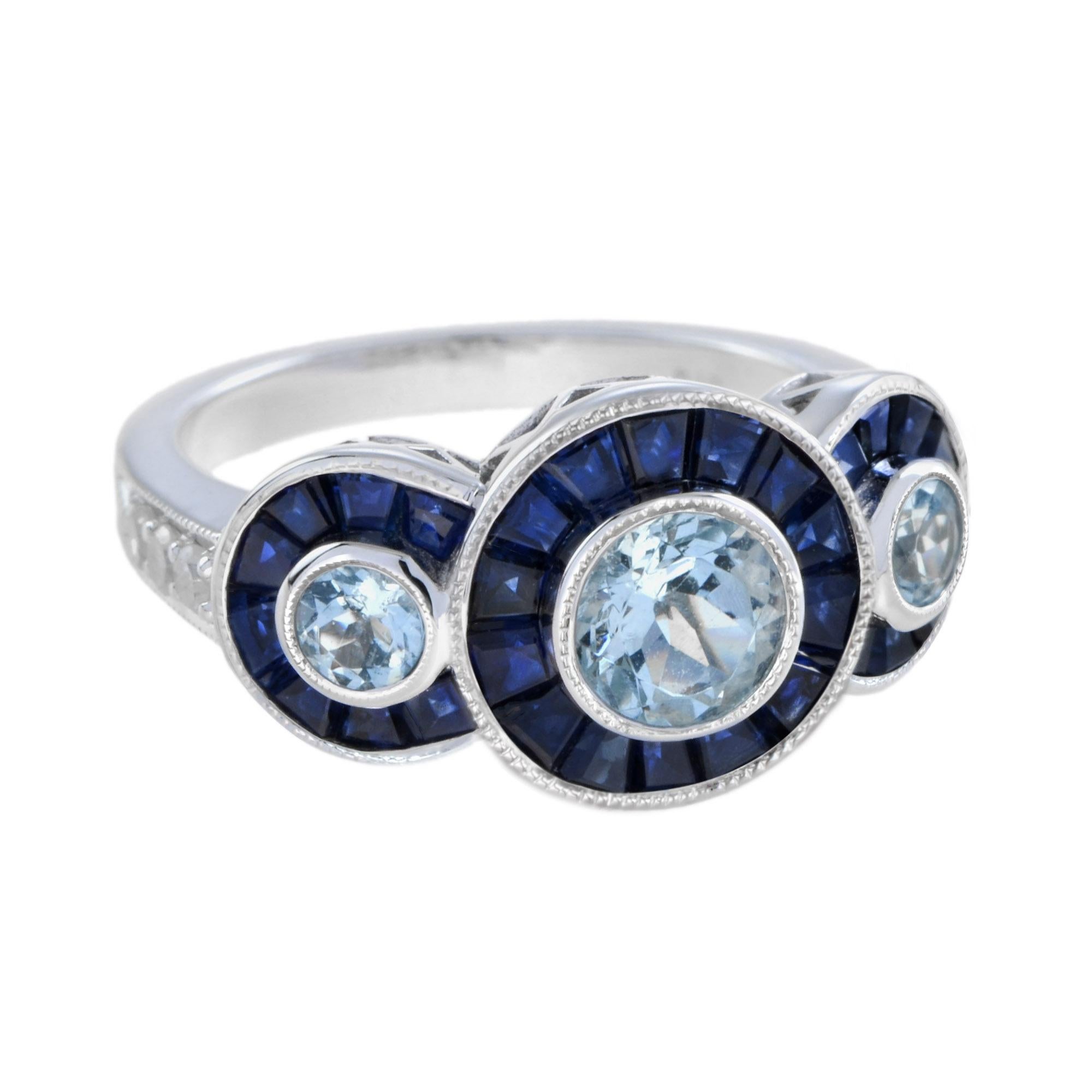 This stunning antique design ring features three bezel set round aquamarine bordered with thirty calibre cut natural blue sapphires. The top face of the shank is accented with six round cut diamonds. The ring makes a nice statement on the hand.
Ring