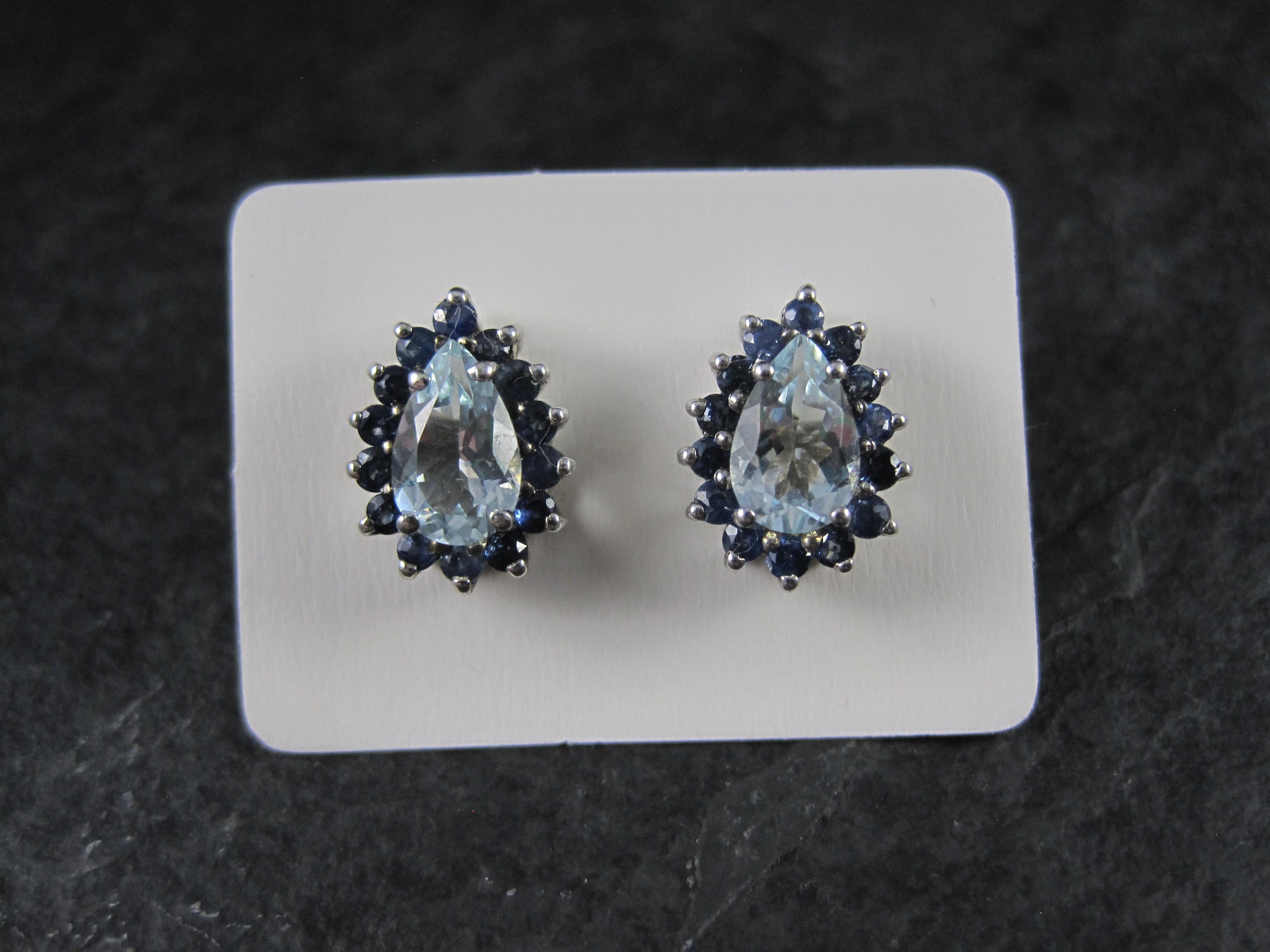 These gorgeous estate earrings are sterling silver.
They feature 1.54 carats in 5x8mm pear cut aquamarines accented by 1.12 carats in 28 round cut, 2mm sapphires.
The earrings measure 3/8 by 1/2 of an inch.
Weight: 2.5 grams
Marks: 925, Chuck