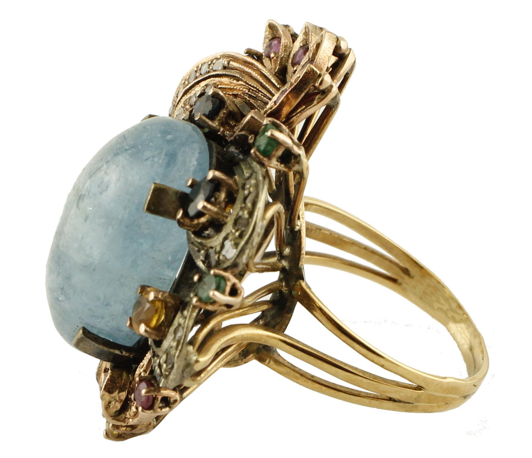 Fantastic ring in 9 kt rose gold and silver, (length 3.1 cm x 2.7 cm width), studded with 0.50 ct of diamonds, 1.92 ct of sapphires, rubies, emeralds and 3.30 g of milk aquamarine. 
Diamonds ct 0.50
Sapphires Rubies Emeralds ct 1.92
Aquamarine g
