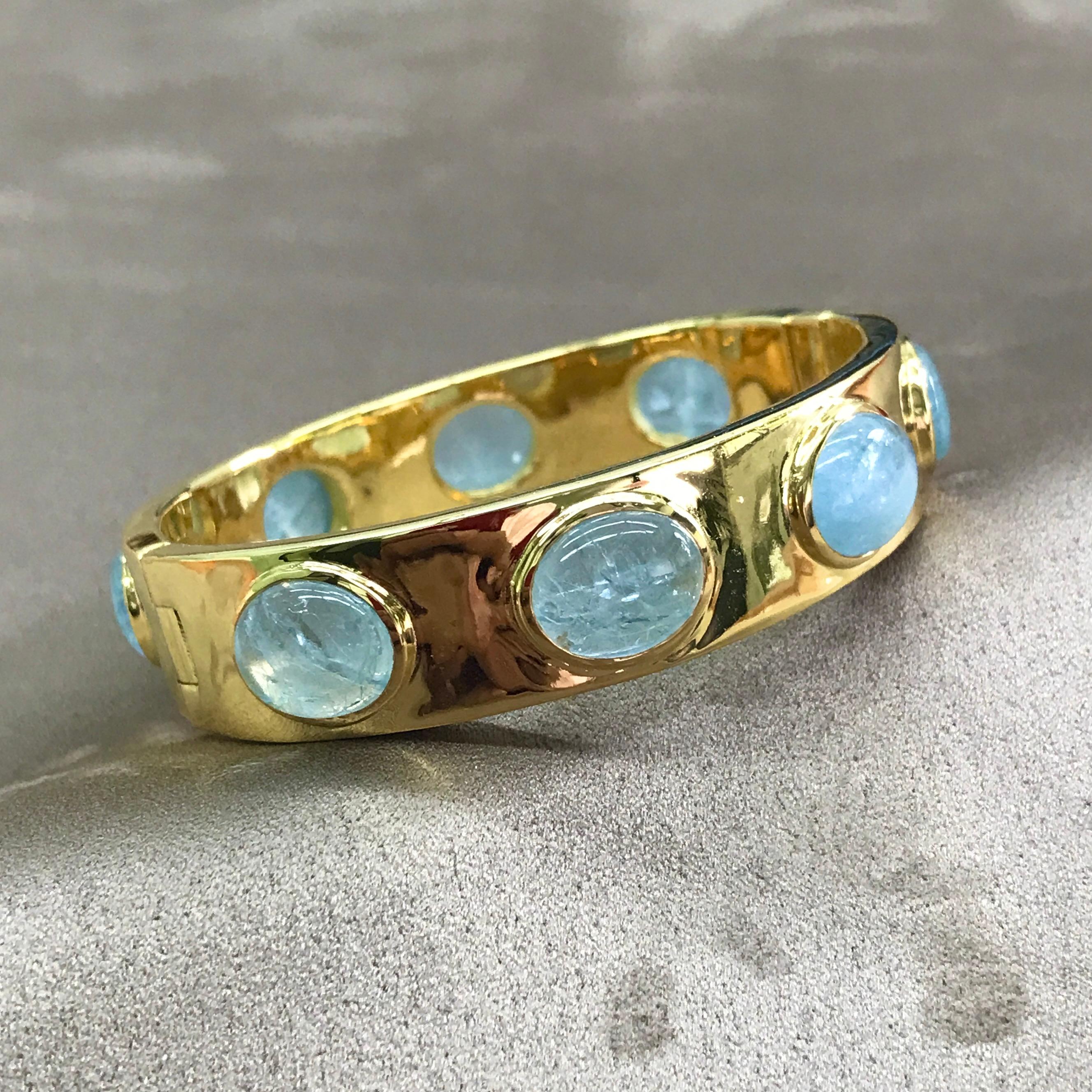 An extremely stylish, substantial and elegant hinged cuff, bezel set with 8 cabochon Aquamarine of nice colour.  We love the proportions of this cuff - discreet enough to be worn everyday, yet striking enough to be noticed in any surrounding. 

The