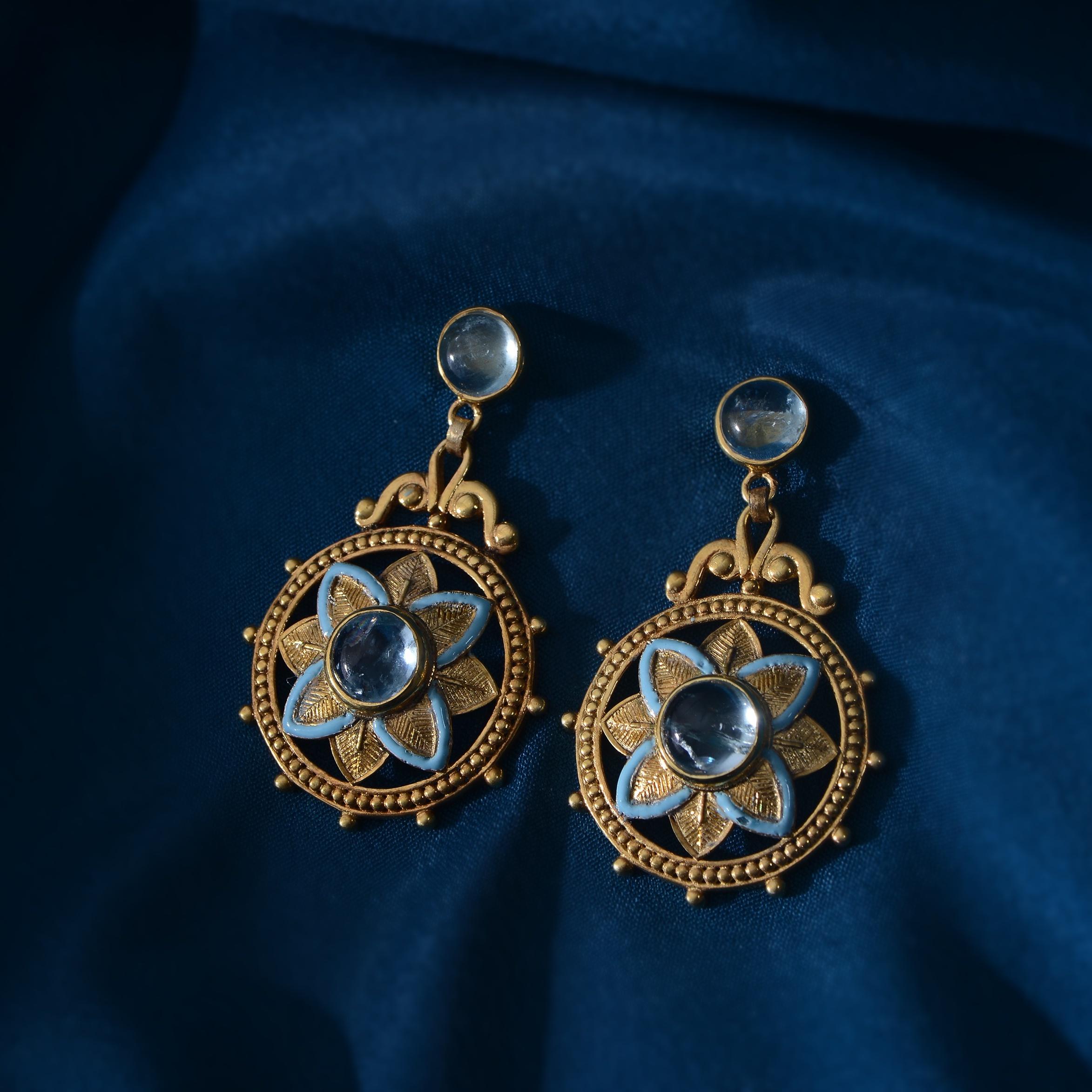 

These gorgeous aquamarine dangle statement earrings have been handmade in our workshops.

Using intricate jaali work mixed with hand engraving and embossed work, they are embedded with aquamarines and surrounded with enamel. The earrings are made