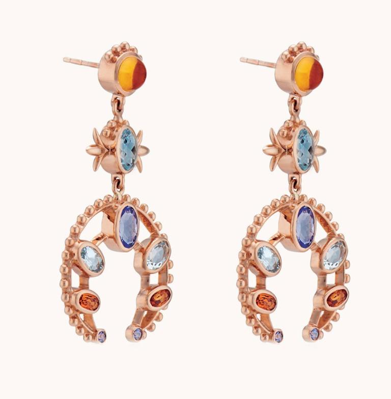 These Marlo Laz 14 Karat rose gold Aquamarine, Tanzanite, and orange Citrin squash blossom earrings are inspired by the southwest and an ode to Native American Navajo jewelry. 

From the Desert Rising collection, these earrings are available for