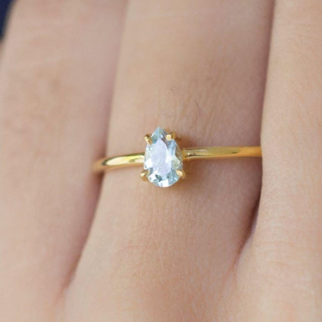 Handmade item
Materials: Gold, Rose gold, White gold
Gemstone: Aquamarine
Gem color: Blue
Band Color: Gold
Style: Minimalist

Thin minimalist ring with the dainty teardrop shape aquamarine stone. Perfect choice as an engagement ring, Valentine's day