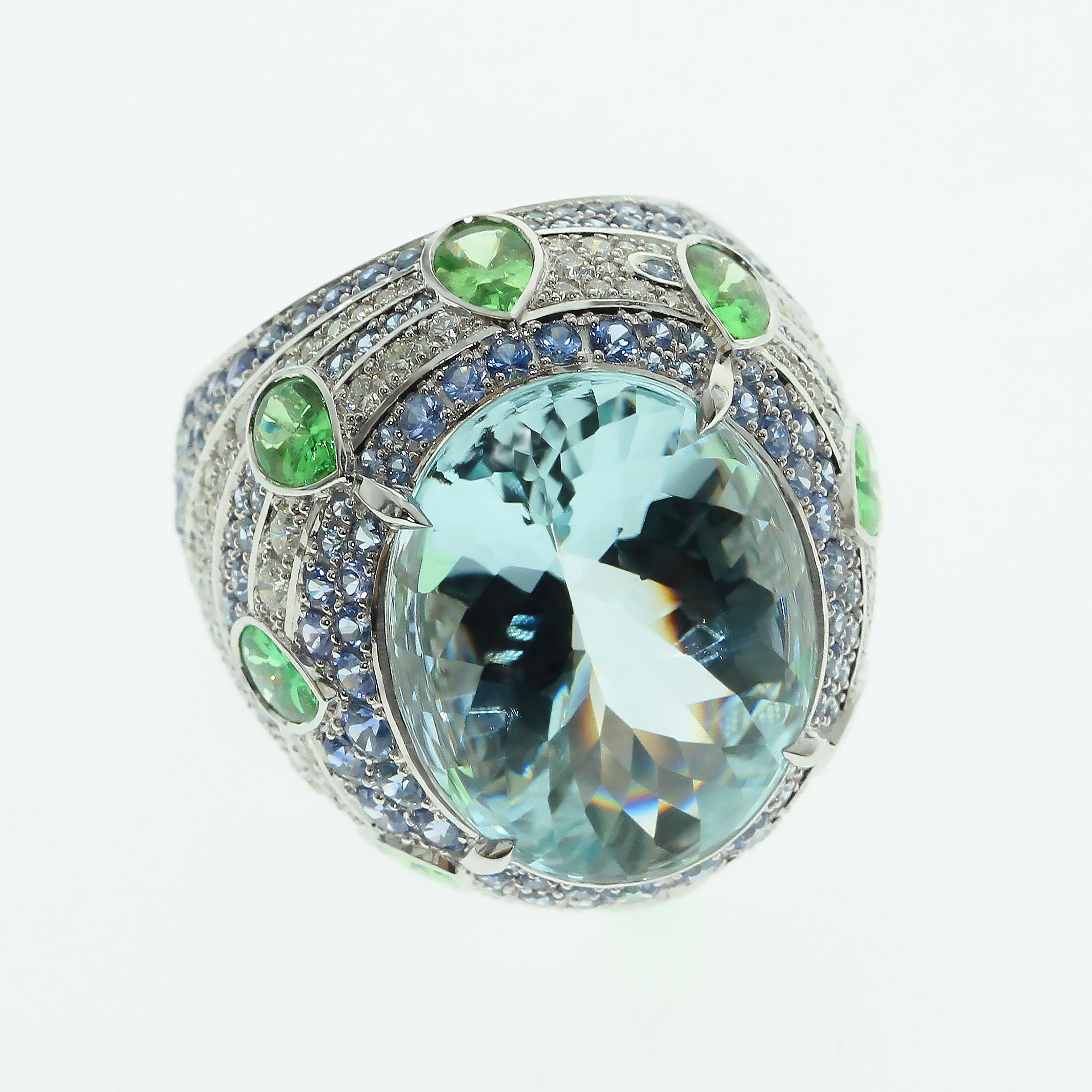 Aquamarine 15.27 carat, Tsavorite Diamonds Sapphire 18 Karat White Gold Oriental Ring 
Aquamarine have bufftop Oval cut, the crown is cabochon and pavilion is faceted 
This cut looks very vibrant with the Aquamarine, Tsavorites are supported the
