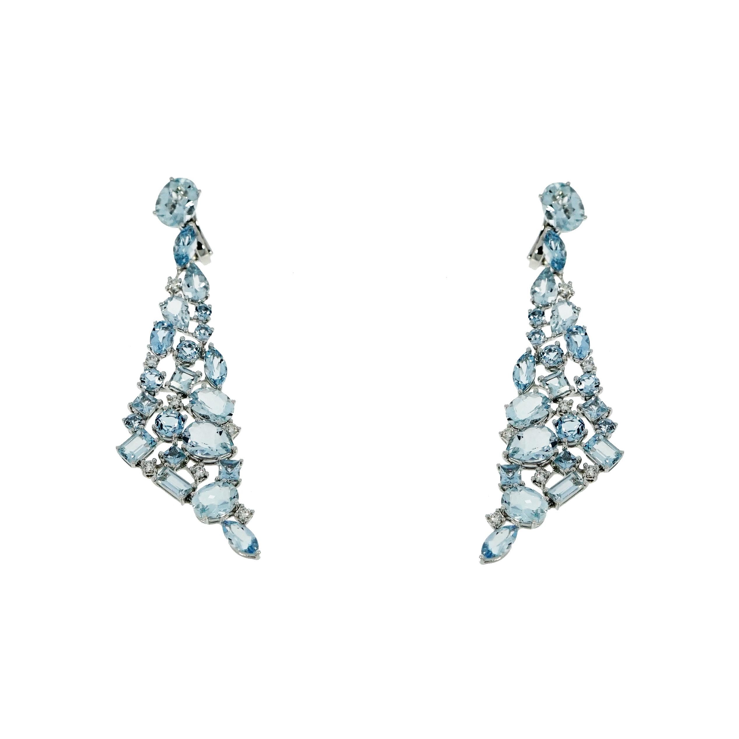This Aquamarine Drop Earrings features an amazing cascade of multi-shaped Aquamarines in a sky blue hue set in 18k white gold with scattered Diamonds in a very distinctive design. The elongated triangle drops are elegantly hanging from an oval