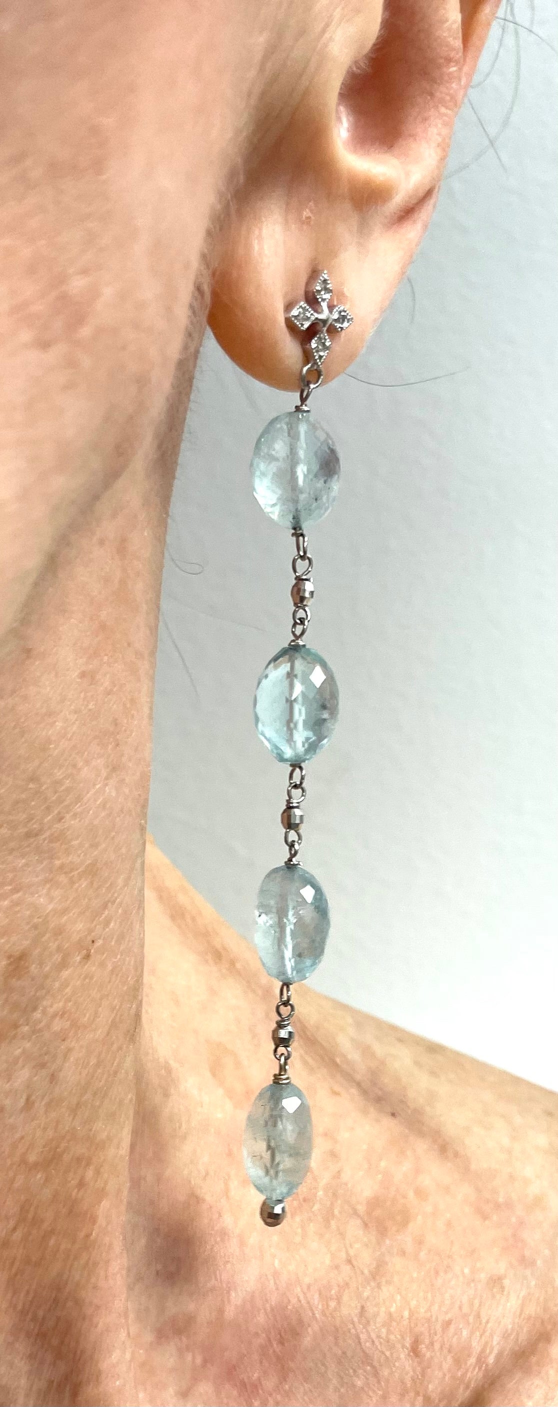 Description
Beautiful, calming Aquamarine individually wire wrapped suspended from pave diamond ear posts and accented with small white gold faceted balls to create a harmonious feminine style. 
Item # E3350
Check out matching necklace Item # N3750,