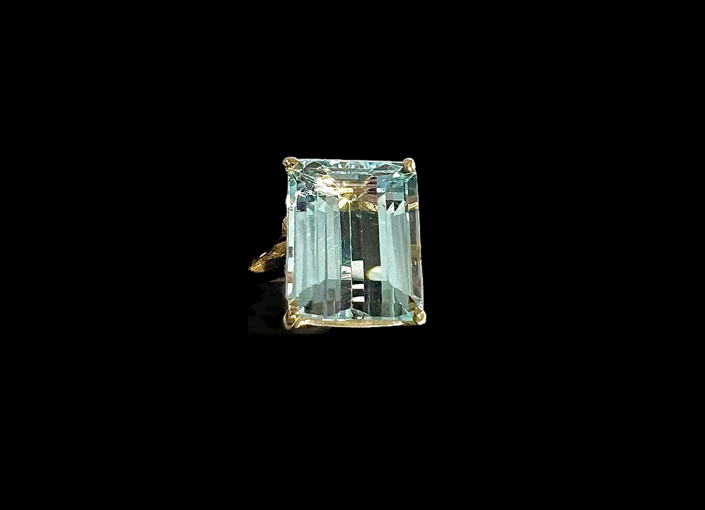 Aquamarine Yellow Gold Ring, circa 1970s
This solitaire aquamarine yellow gold ring exudes elegance and sophistication. Its vibrant emerald-cut aquamarine gemstone captures the beauty of the ocean with its mesmerizing light blue hue, while the