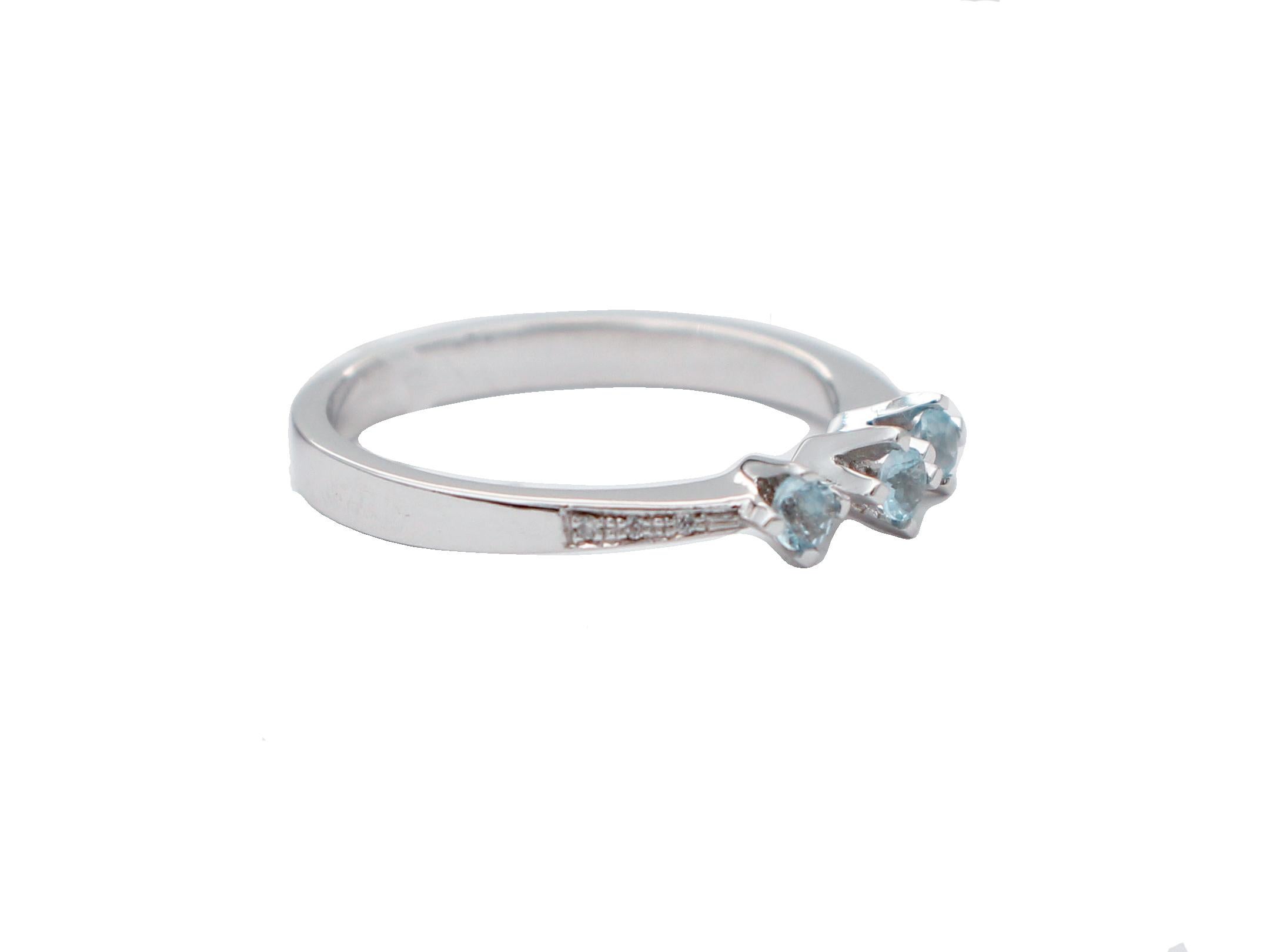 Elegant modern ring in 18 karat white gold structure mounted with three aquamarine and surrounded by little diamonds laterally.
Diamonds 0.03 ct
Aquamarine 0.23 ct
Total Weight 3.00 gr
RF  +CIA
Italian Size 14
French Size 54
Usa Size 6.84

For any