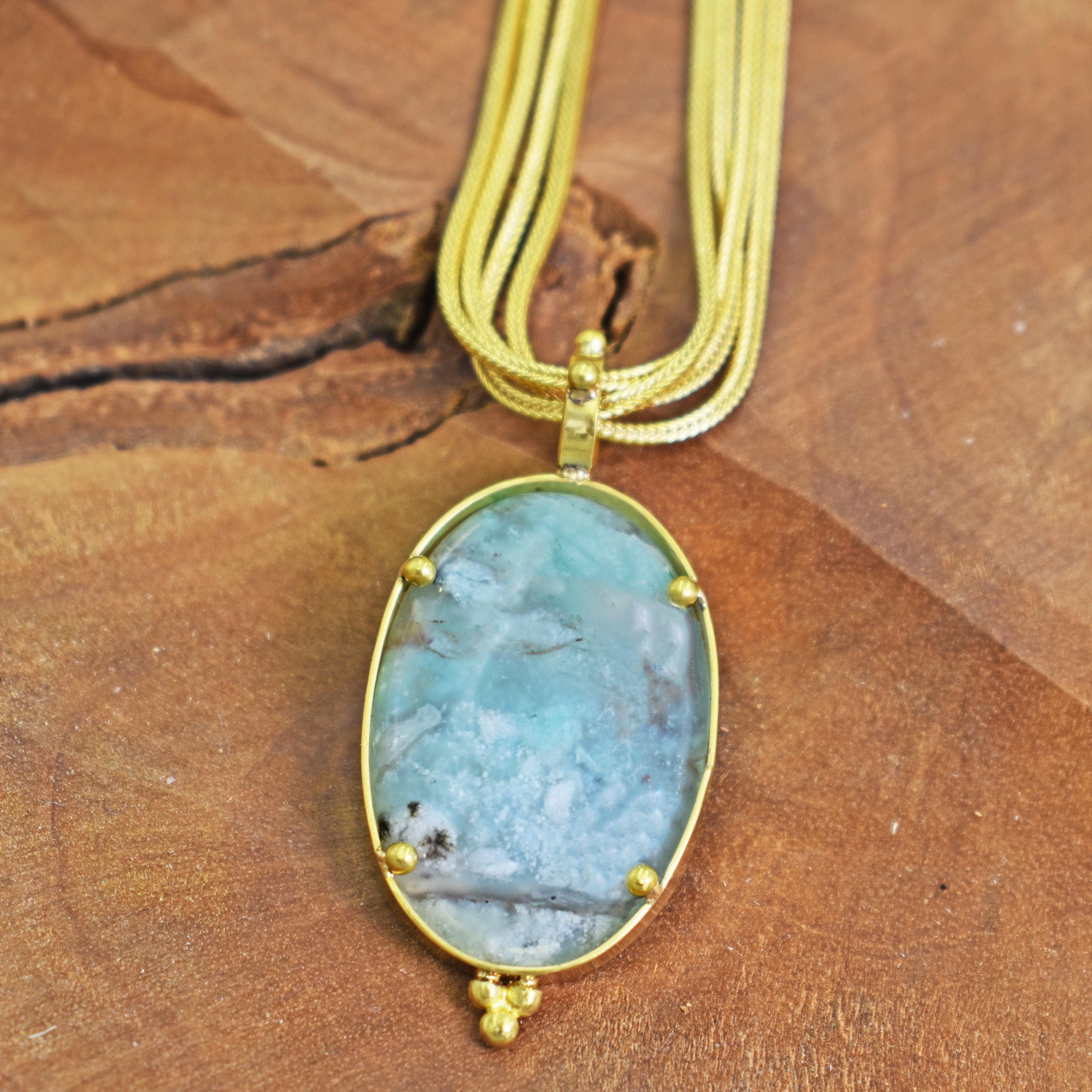 Gorgeous, one-of-a-kind Aquaprase and 22k yellow gold pendant with beaded details on a four-strand 18k gold foxtail chain necklace. Aquaprase is one of the most recently discovered gemstones, being unearthed in 2014 by a gem explorer in Africa. Its'