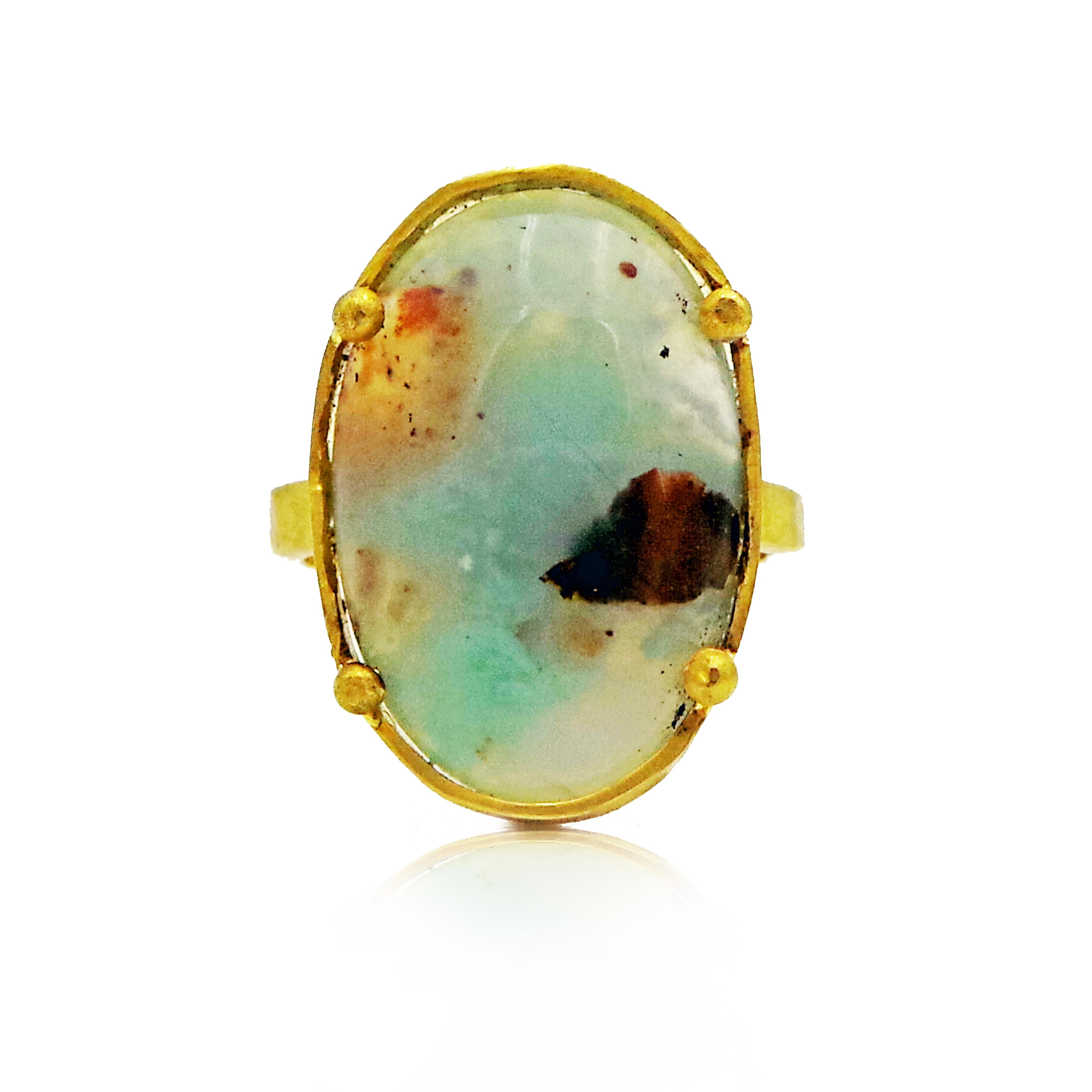 Oval Aquaprase gemstone set in 22k yellow gold hand-forged cocktail ring finished with a hammered, rustic texture. Size 7. Aquaprase is one of the most recently discovered gemstones, being unearthed in 2014 by a gem explorer in Africa. Its