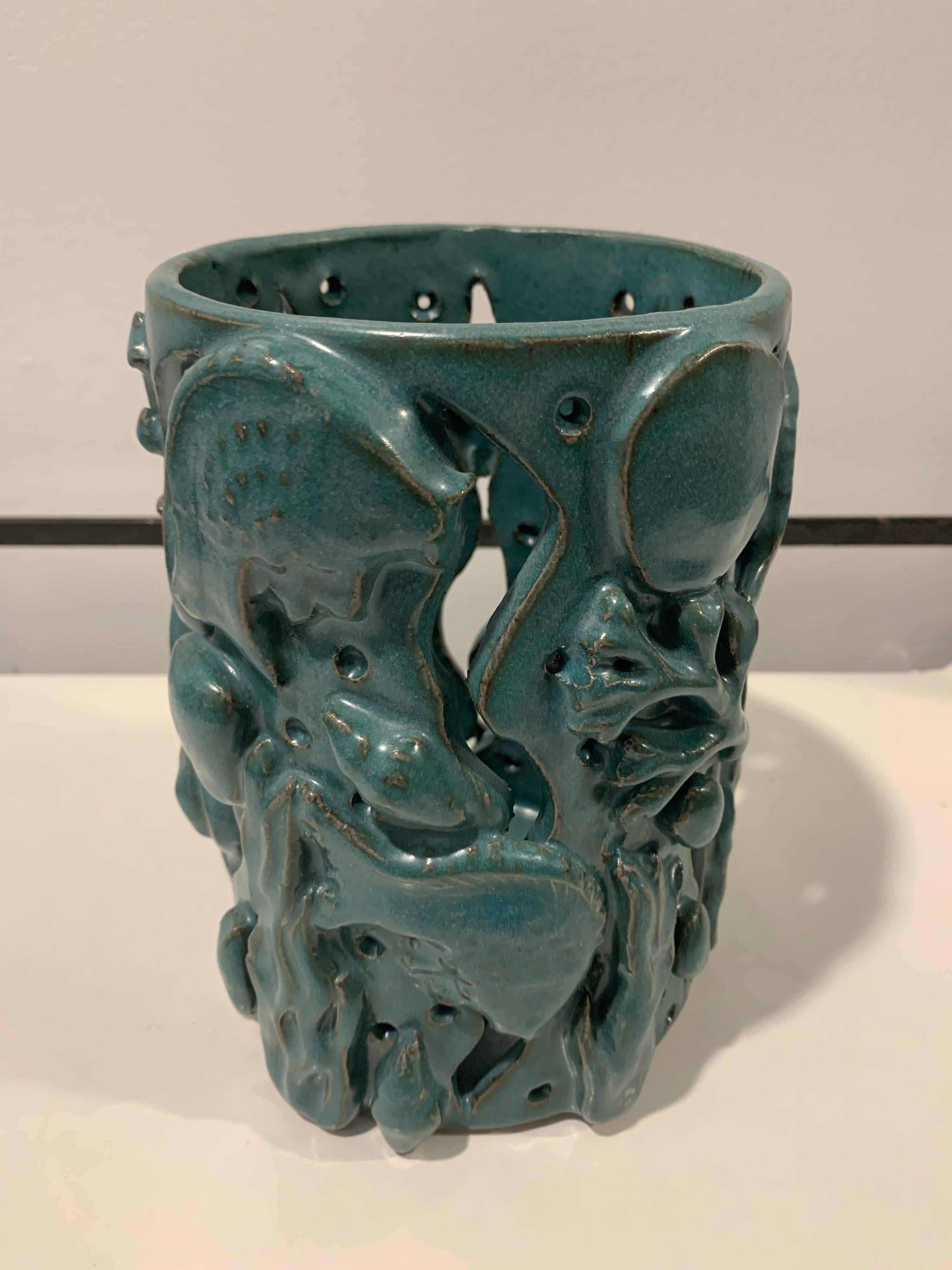 This beautiful handmade pottery vessel for orchids, brush holder, etc., with an “Aquarium” theme. Fish and marine plants throughout this amazing turquoise piece.