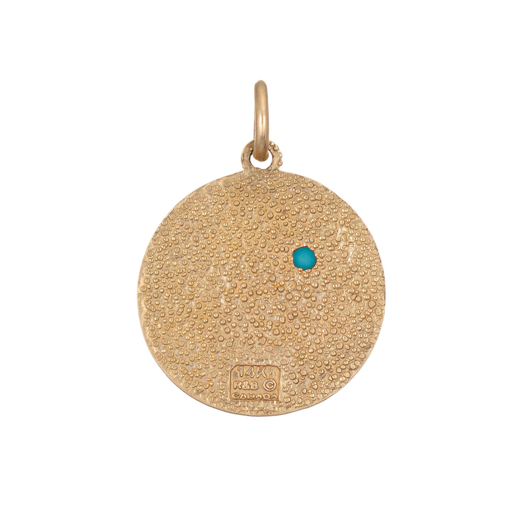 Finely detailed vintage Aquarius charm crafted in 14k yellow gold.  

The unique charm highlights the water sign, Aquarius. A small piece of cabochon cut turquoise measures 2mm. The bale measures 3mm and can accommodate a thin to medium thickness