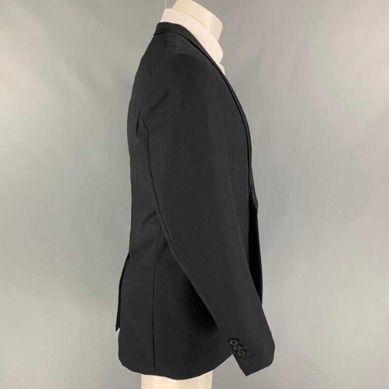 AQUASCUTUM sport coat comes in a black wool with a full liner featuring a shawl collar, slit pockets, single back vent, and a single button closure.
Very Good
Pre-Owned Condition. 

Marked:   40 R 

Measurements: 
 
Shoulder: 17.5 inches  Chest:
40