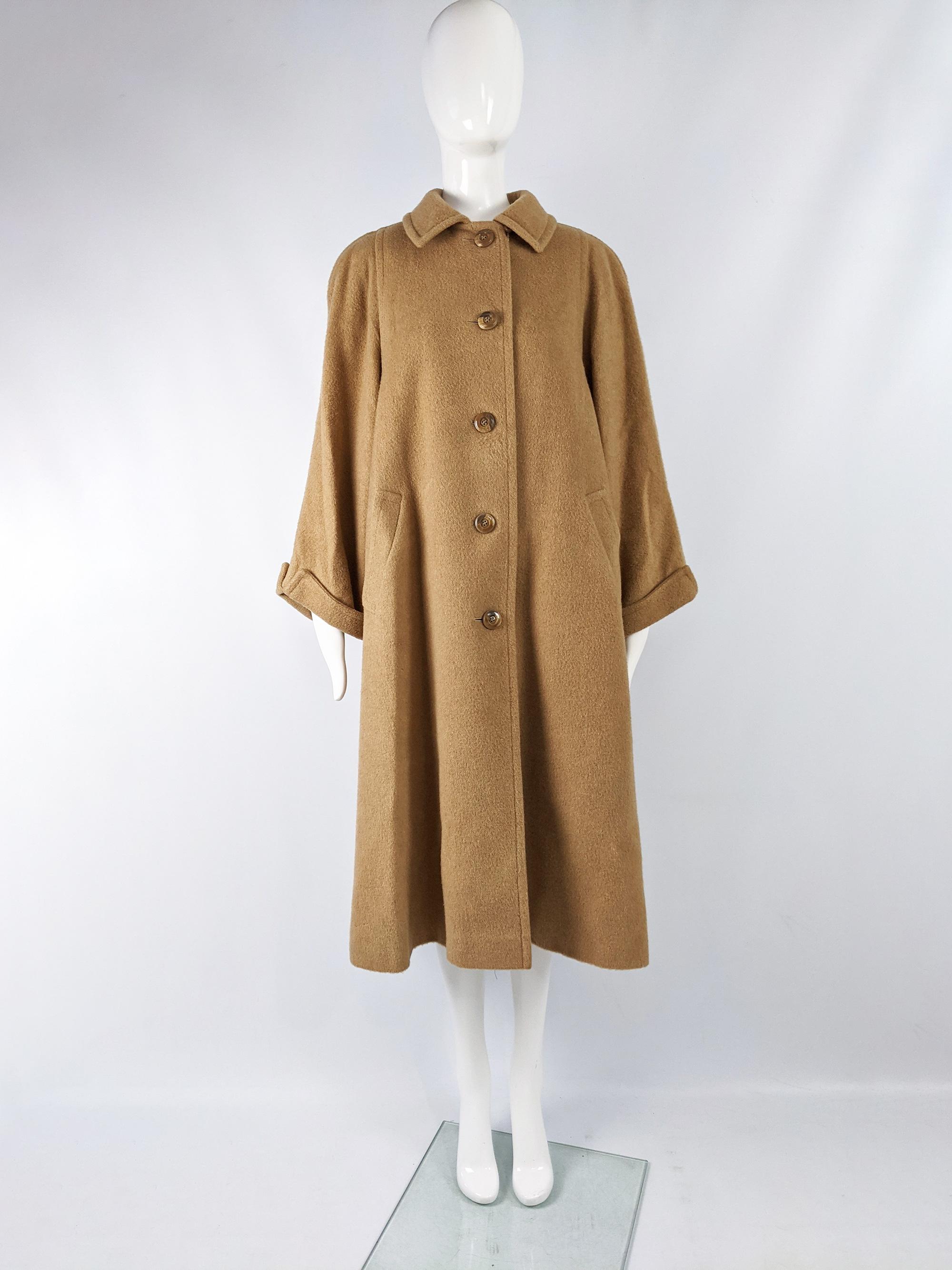 A fabulous vintage womens swing coat from the 60s by luxury British fashion house, Aquascutum. In a brown pure camel hair with wide sleeve and an oversized trapeze fit.

Size: Marked UK 10 which equates to a US 6/ EU 38 but this gives a huge,