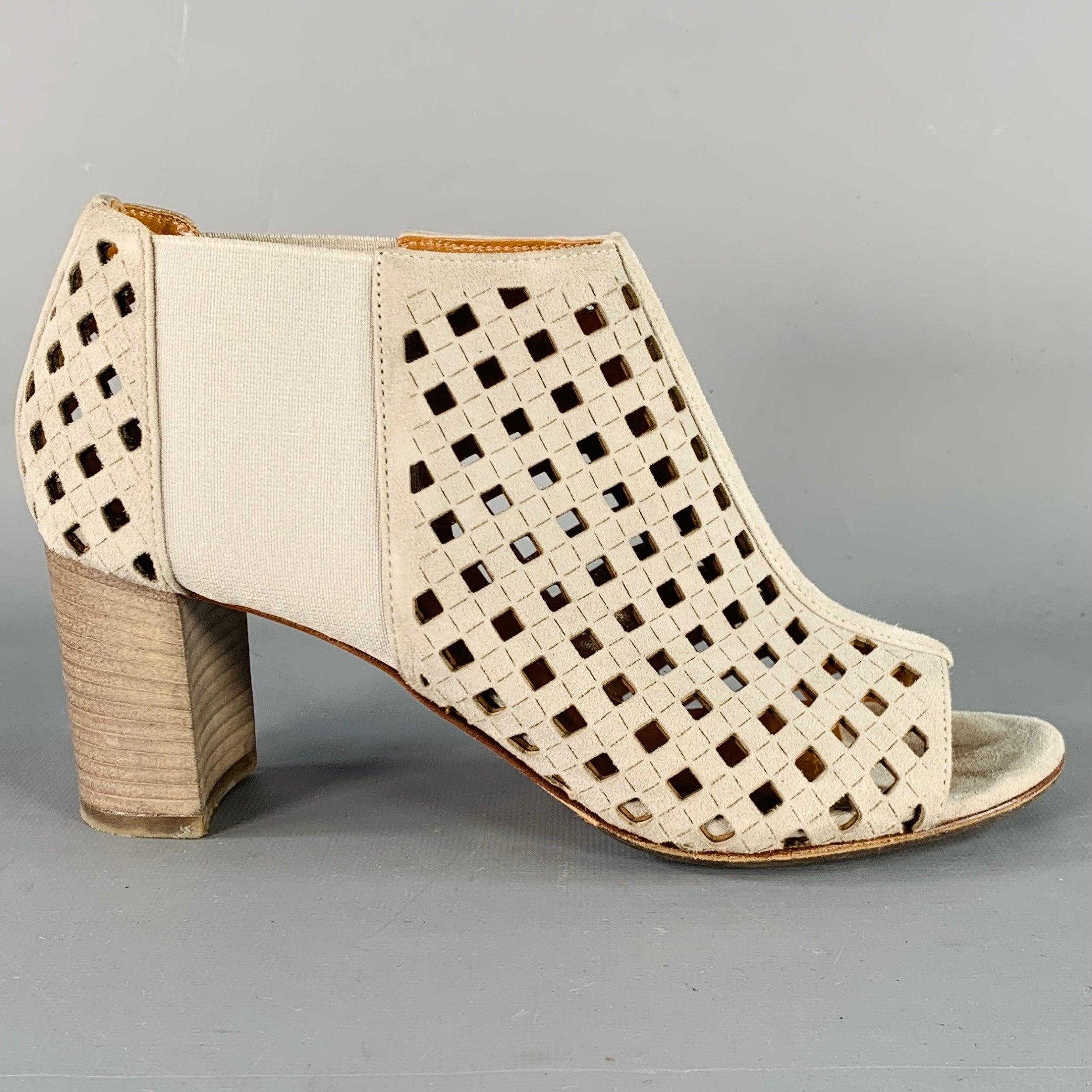 AQUATALIA boots
in a grey suede featuring an ankle style, perforated design, elastic side panels, and stacked heel. Comes with dust bag. Made in Italy.Excellent Pre-Owned Condition. 

Marked:   7.5 

Measurements: 
  Length: 9 inches Width: 3.25