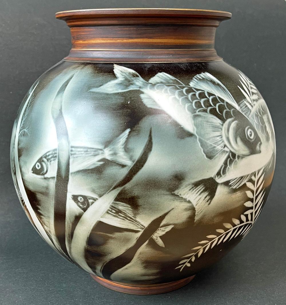 Large and striking, this unique vase by Gunnar Nylund for Rorstrand presents a host of aquatic creatures in an underwater scene, including a seahorse, various fish and seaweed, all in a greenish-black and ivory palette. The vase is an excellent