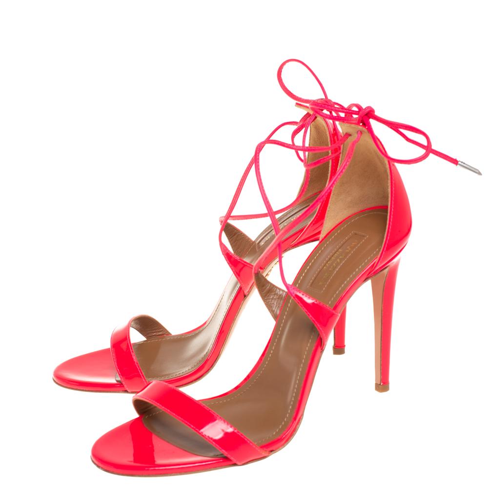The barely-there silhouette of Aquazurra's Linda sandals is what makes them so covetable! Beautifully made from patent leather in a pink hue, they are adorned with slender straps that elegantly form an open-toe design. These sandals are secured with