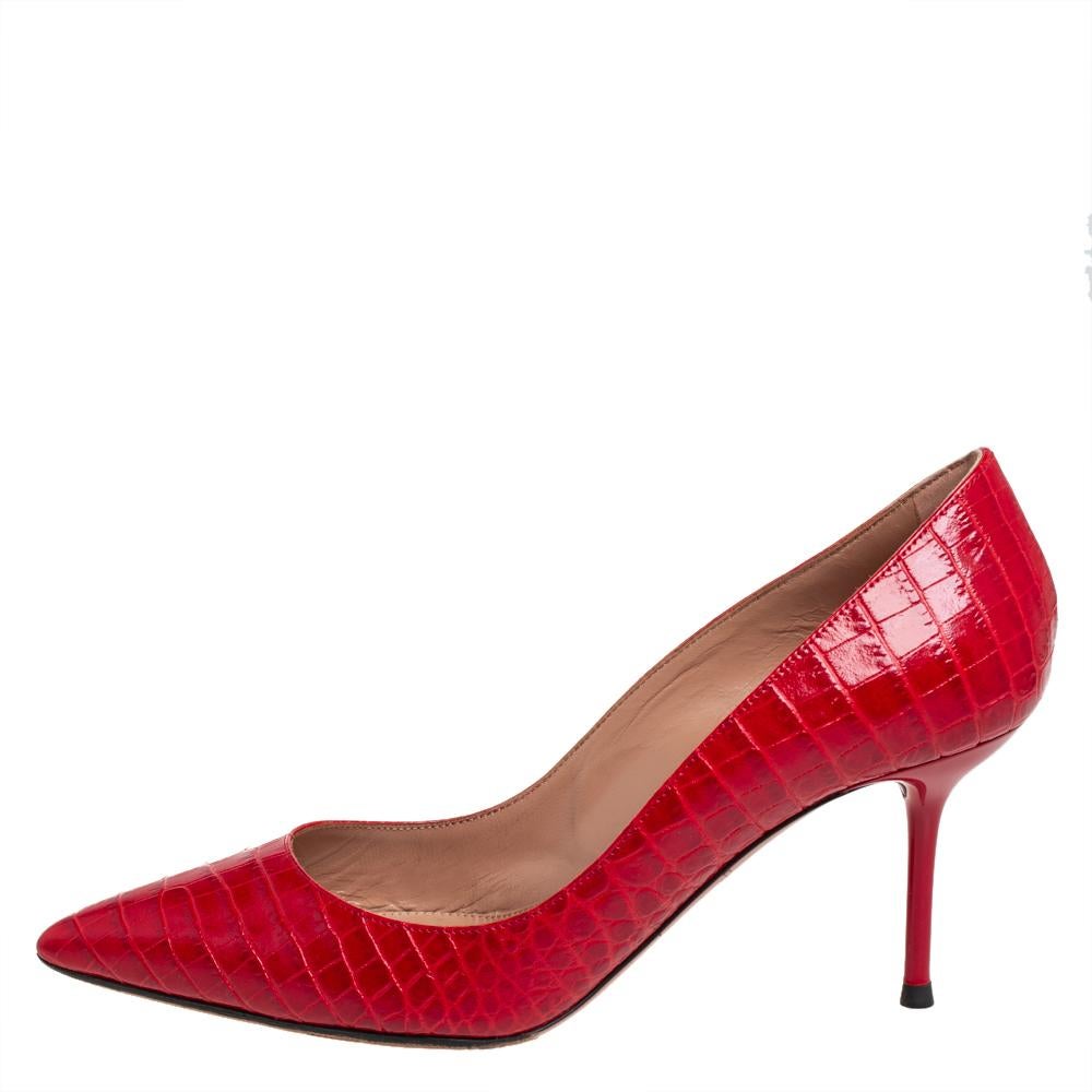 These stylish Purist pumps come from the house of Aquazzura. Crafted in Italy, they are made from red croc-embossed leather and are great for evenings. They are styled with pointed toes and 7 cm heels. They are finished with rubber soles and