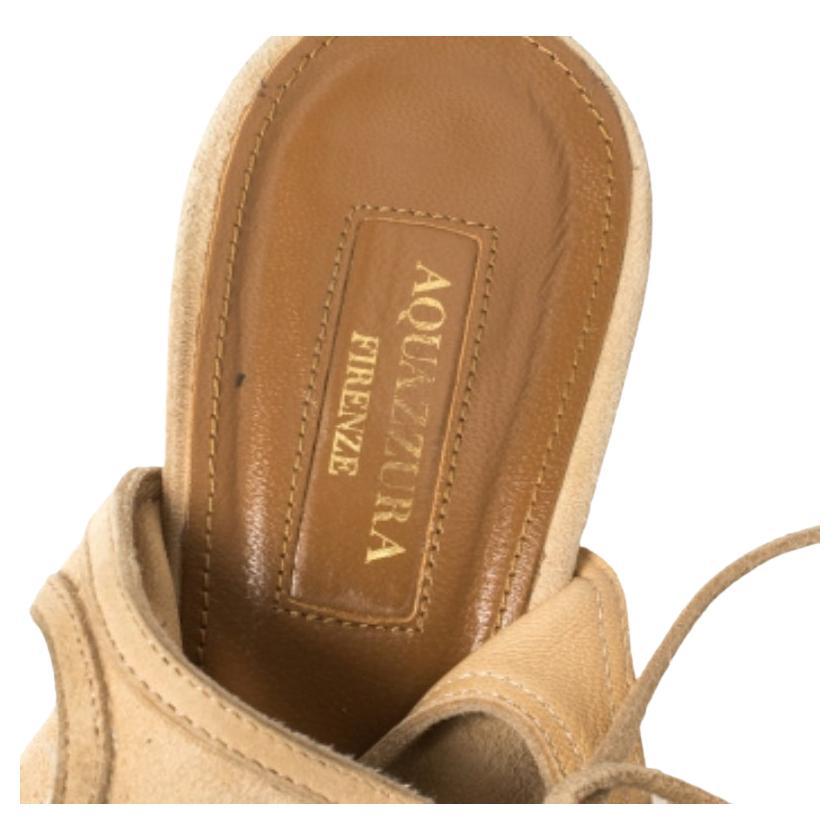 Aquazzura's elegant cutout sandals are crafted from beige suede with wedge heels and cushioned insoles. These versatile sandals are designed with open toes and ankle ties. Wear yours with anything from cropped pants to pencil skirts.