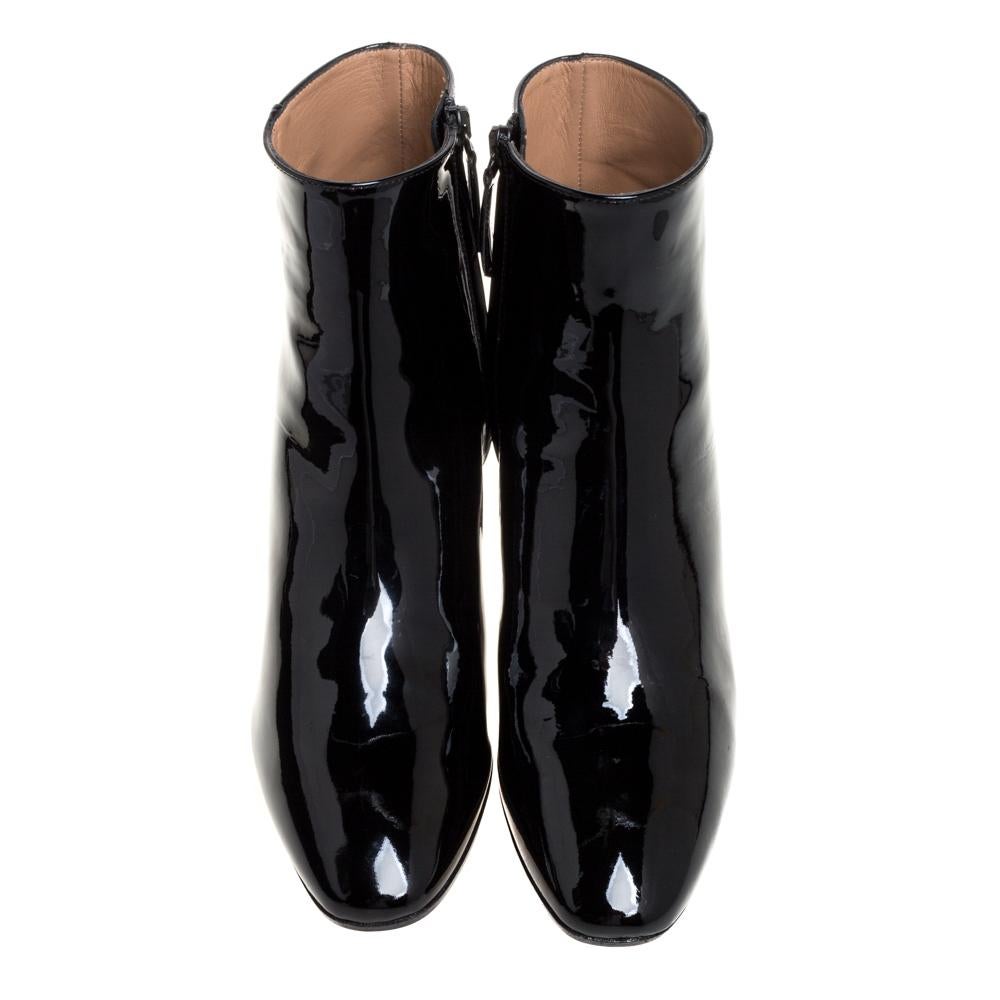 Let these patent leather booties elevate your style this season. The trendy black pair from Aquazzura is crafted from patent leather and set atop block heels to take your style soaring. The booties are lined with leather and secured by