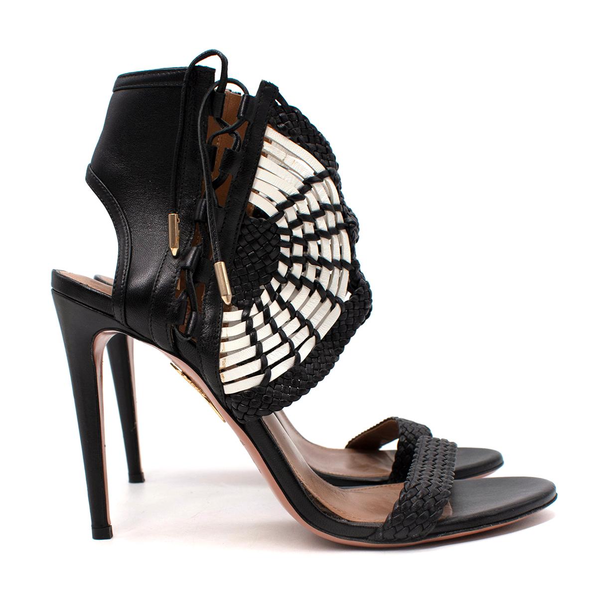 Aquazzura Black & White Leather Braided Heeled Sandals

- Round shaped toe heeled sandals with braided leather fan effect detail on the ankle
- Side ankle zip
- Set on a high stiletto heel
- Lined in tan brown leather

Materials
Leather

Made In