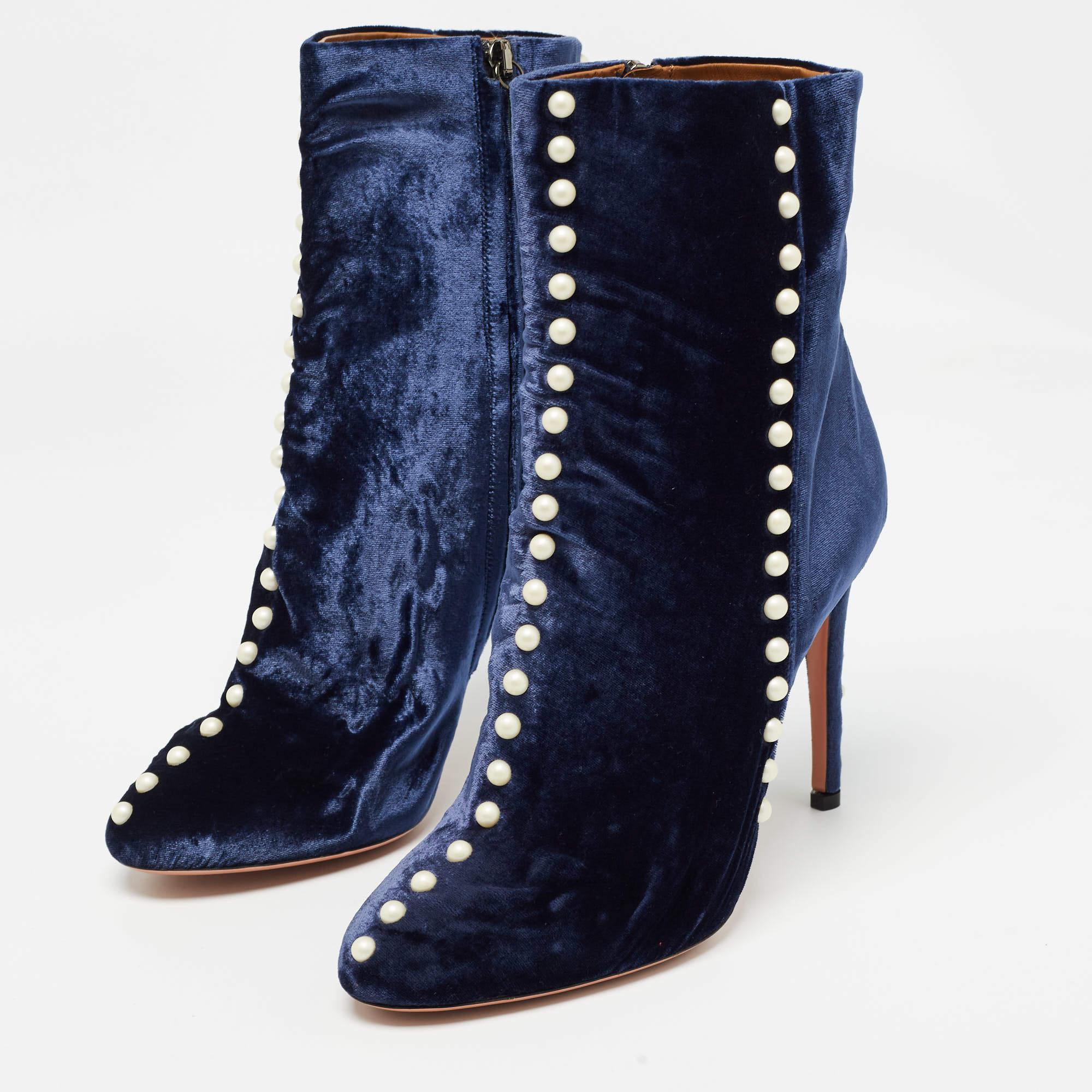 Crafted in sumptuous blue velvet the Aquazzura ankle boots exude opulence. Adorned with delicate pearls these boots add a touch of whimsy to any ensemble. The sleek silhouette and sturdy block heel ensure both style and comfort for the modern