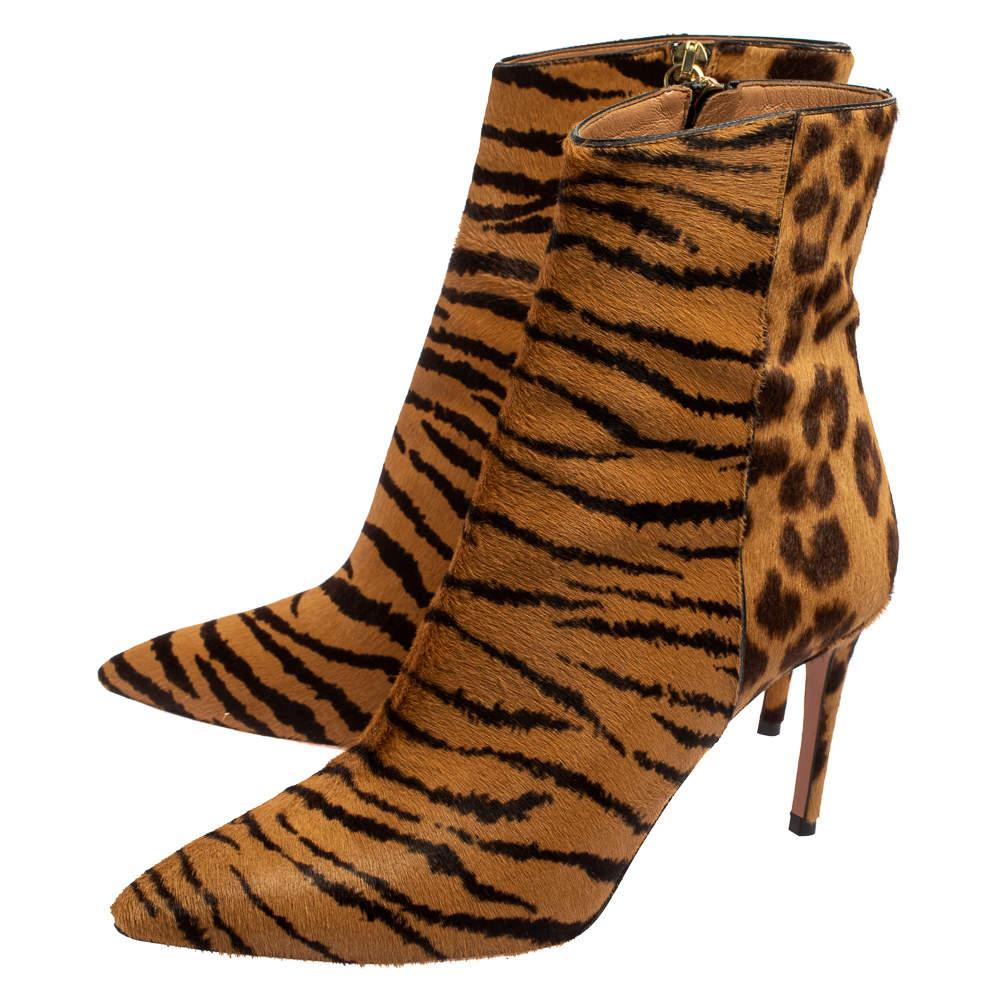 Covered in a mix of leopard prints and tiger stripes, Aquazzura ensures a bold finish with these Alma boots. The calfhair boots feature pointed toes, leather lining, zip closure, and 8.5 cm heels.

