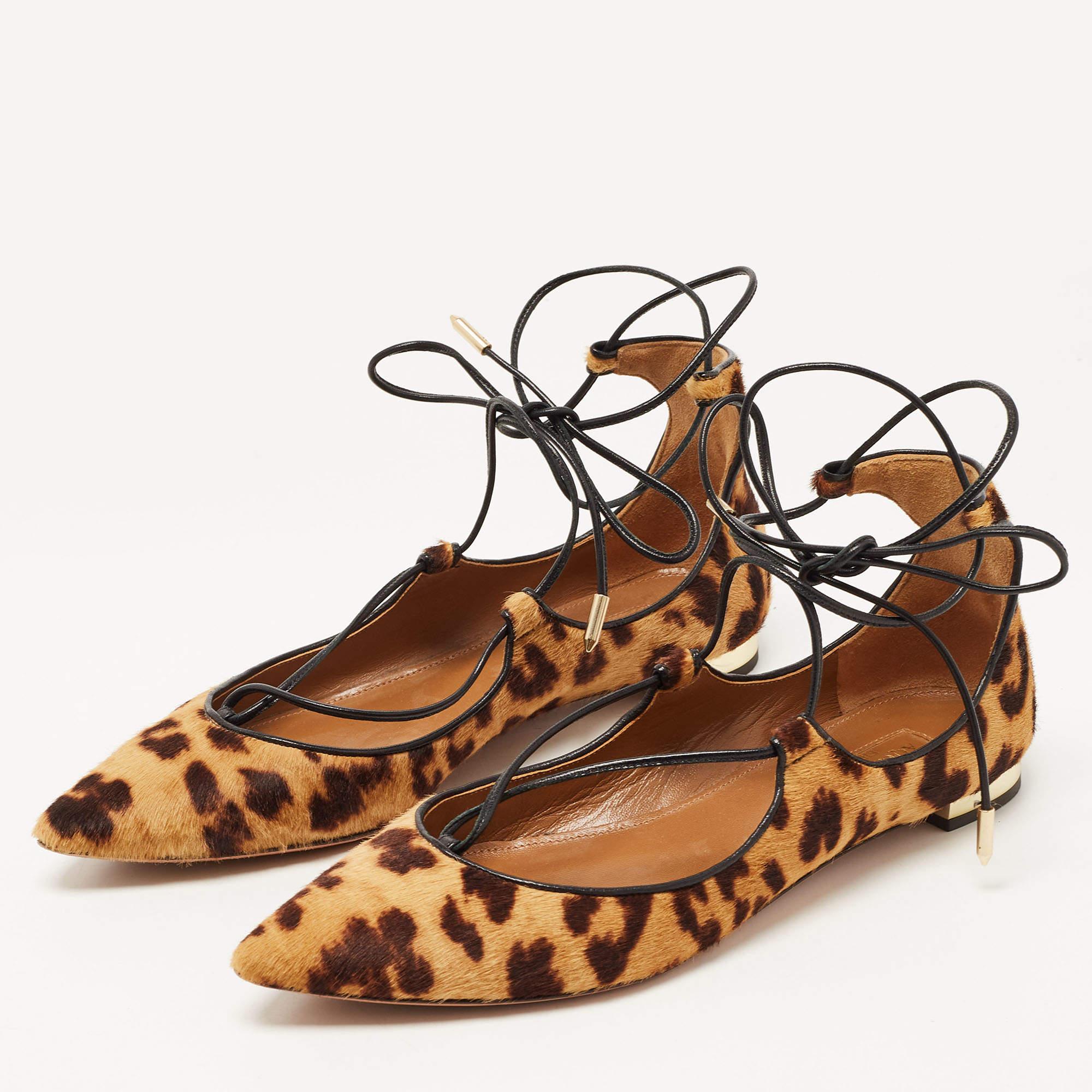 The Aquazzura Christy ballet flats exude elegance and wild charm. Crafted with luxurious calf hair featuring a captivating leopard print  these ballet flats boast a timeless silhouette and are adorned with delicate laces that wrap around the ankle 
