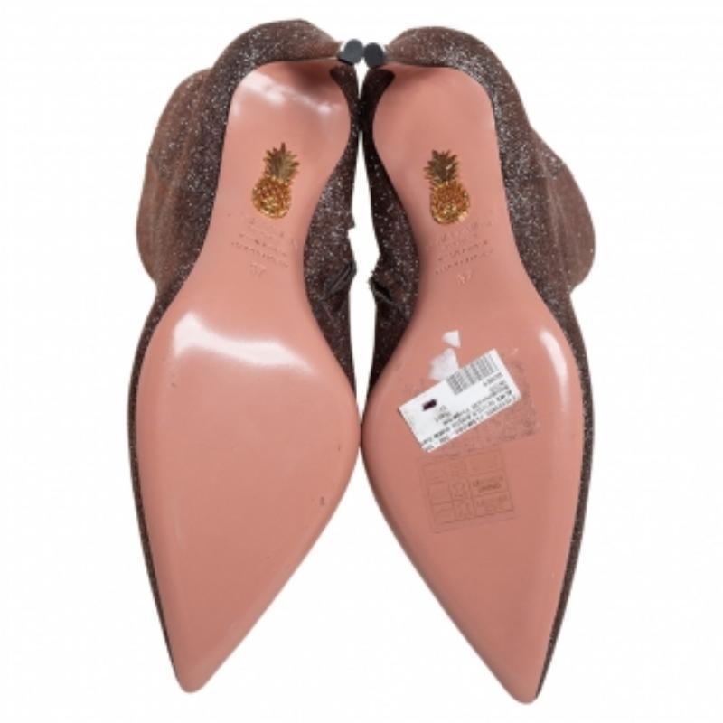 These ankle booties from Aquazzura spell everything chic and modern! They are crafted from brown lurex fabric and designed with pointed toes and side zippers. They are equipped with comfortable leather-lined insoles and elevated on 8.5 cm heels.
