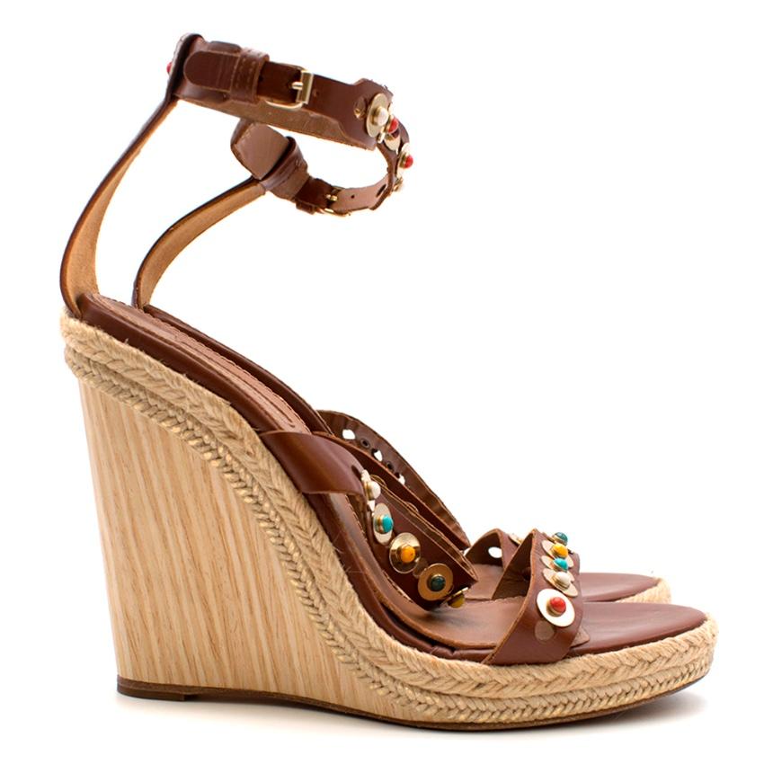 Aquazzura Espadrille Brown Leather Wedges 


Aquazzura's sandals have been crafted from tan lamb leather and have chic embellished gold-toned straps. 

Materials: leather (Upper) 
Lining: leather
Trim: jute and wood 
Sole: leather insole and