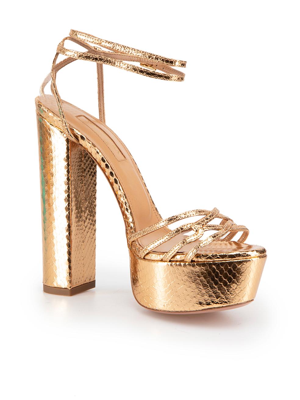 CONDITION is Never worn. No visible wear to shoes is evident on this new Aquazzura designer resale item.

Details
Gold
Leather
Heeled sandals
Snakeskin embossed
Open toe
Platform
Adjustable ankle strap
High heeled
Made in