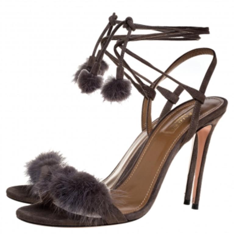 These olive sandals from Aquazzura will make you look elegant and sassy at the same time. They come crafted from suede and feature an open-toe silhouette. The vamp straps are detailed with mink fur and the ankle straps have self-tie fastenings.