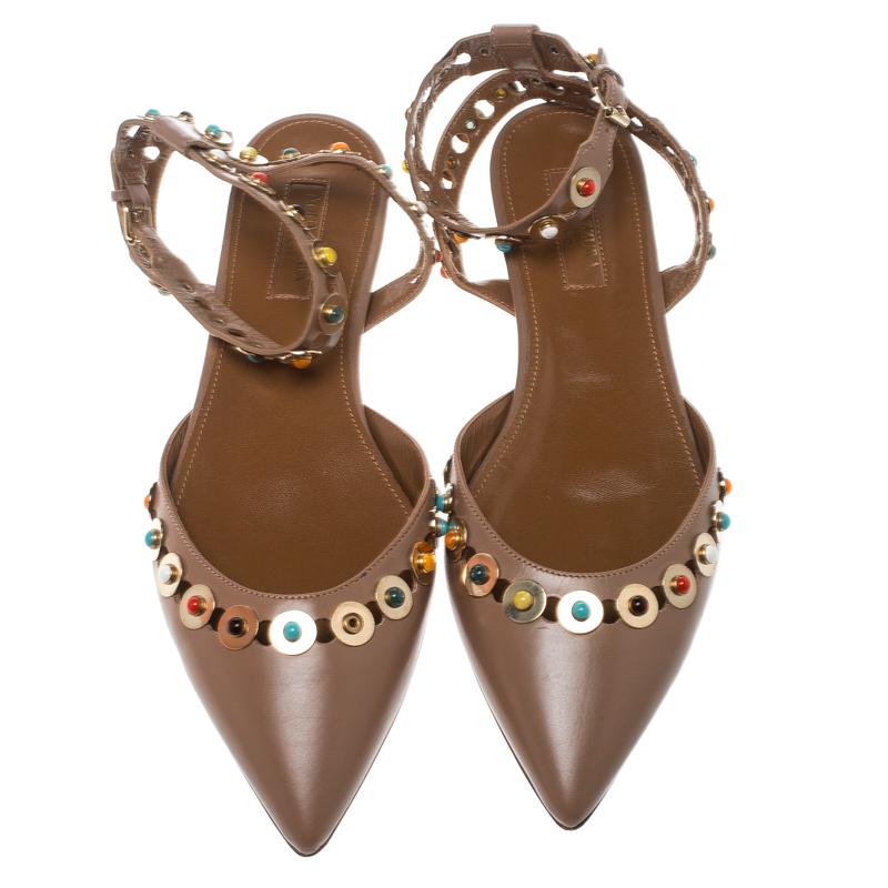 How lovely and elegant do these flat sandals from Aquazzura look! These beige Byzantine sandals are crafted from leather and feature pointed toes, exquisite multicolour cabochon studs detailed on the vamps and the ankle cuffs and leather lined