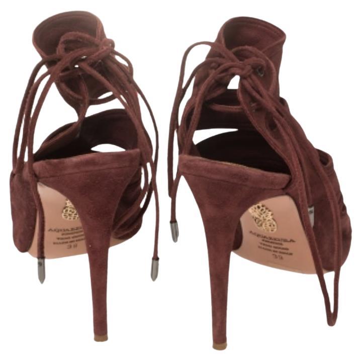 These suede Sloane sandals by Aquazzura will frame your feet beautifully. They come with cutouts on the vamps, peep toes, and high heels. The sandals are lined with leather and secured by ties at the counters.