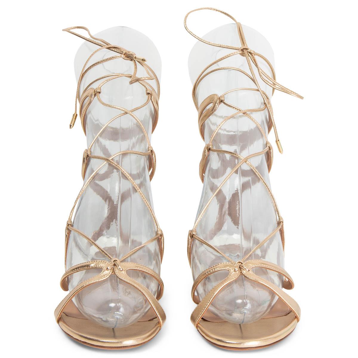 100% authentic Aquazzura Pompei lace-up sandals have a caged gladiator silhouette with slim, curved straps that cradle your feet and ankles made in the label's Italian atelier from supple gold leather. Adjust the lace-up ties to find your perfect