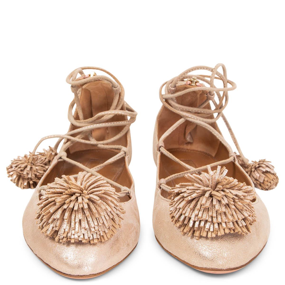 100% authentic Aquazzura Sunshine lace-up ballet flats in nude metallic leather detailed with pom-pom trims. Ghillie tie with back zipper closure. Have been worn once and are in virtually new condition. 

Measurements
Imprinted Size	40
Shoe