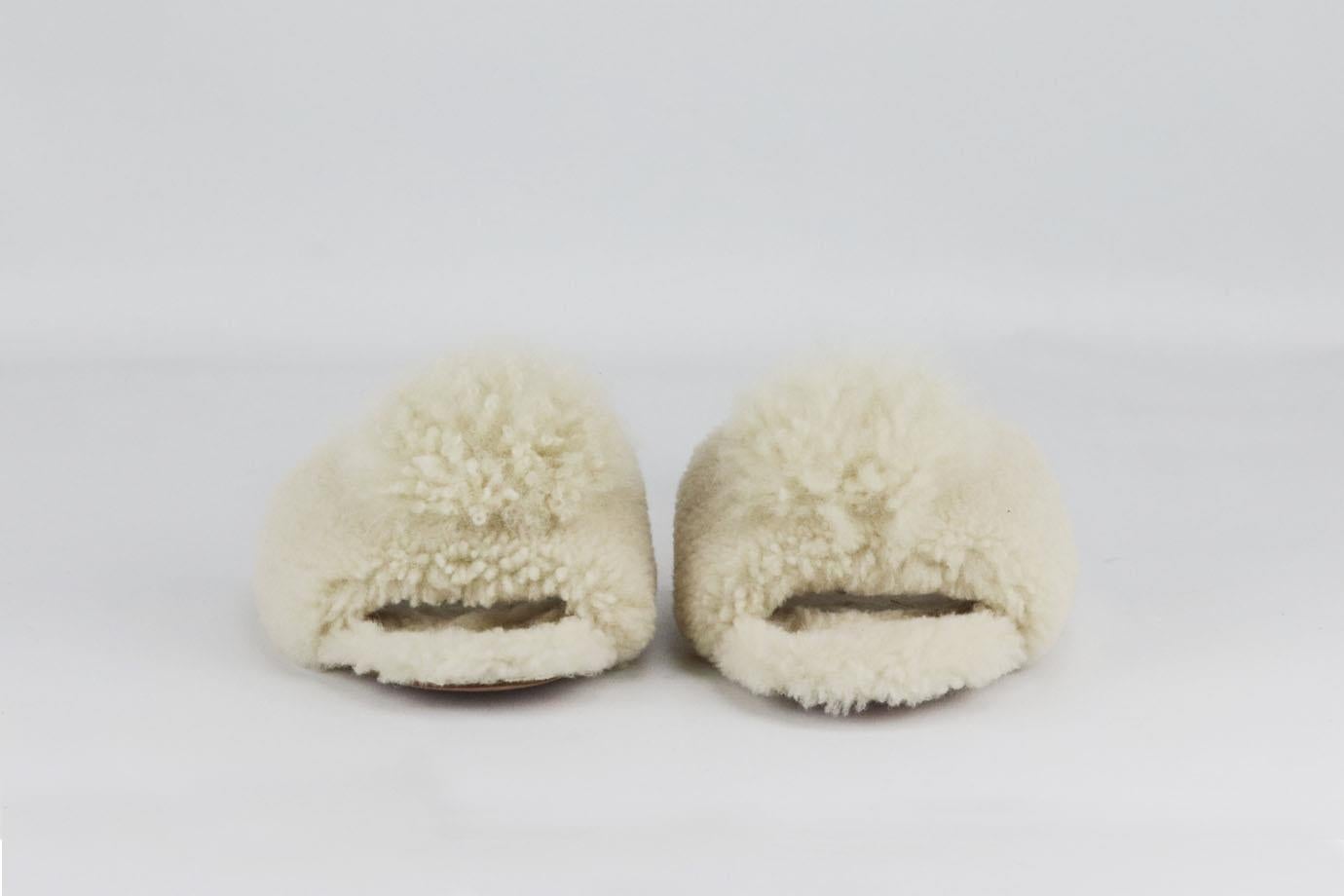 Aquazzura pom pom embellished shearling slides. Cream. Slip on. Does not come with dustbag or box. Size: EU 38 (UK 5, US 8). Insole: 9.6 in. Heel: 0.7 in Very good condition - Light wear to soles; see pictures.

