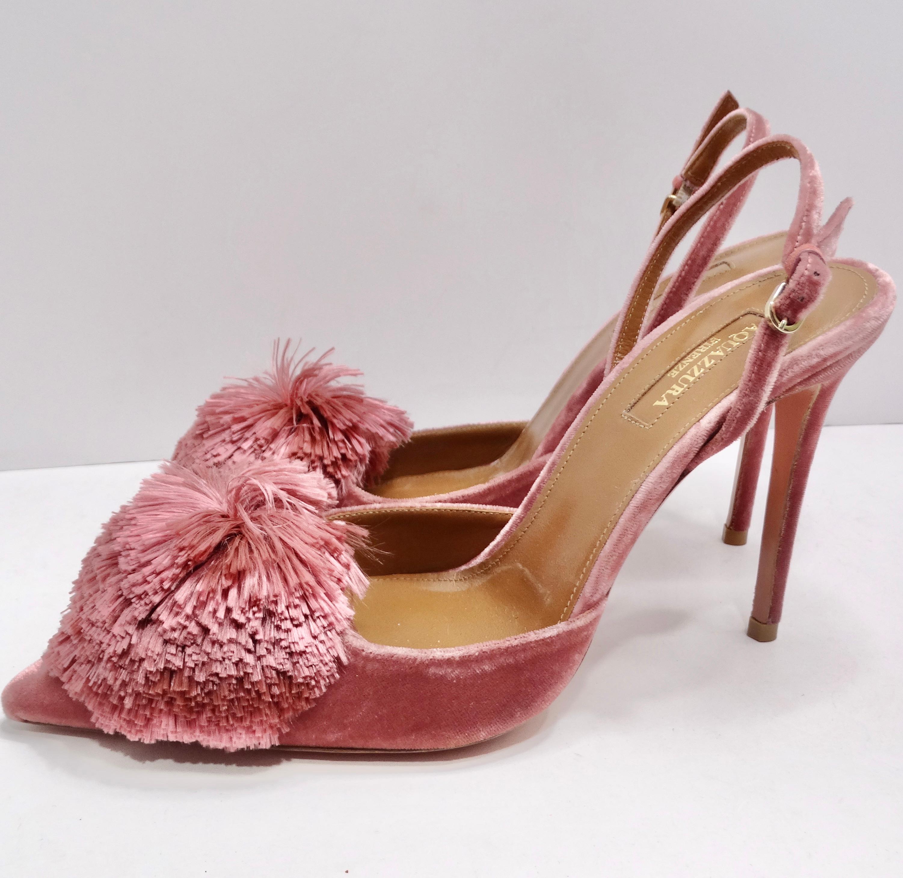 Introducing the Aquazzura Powder Puff Slingback Heels—a captivating pair that seamlessly marries elegance with a playful touch. These light pink velvet slingback heels aren't just footwear; they're a wearable work of art designed for those who