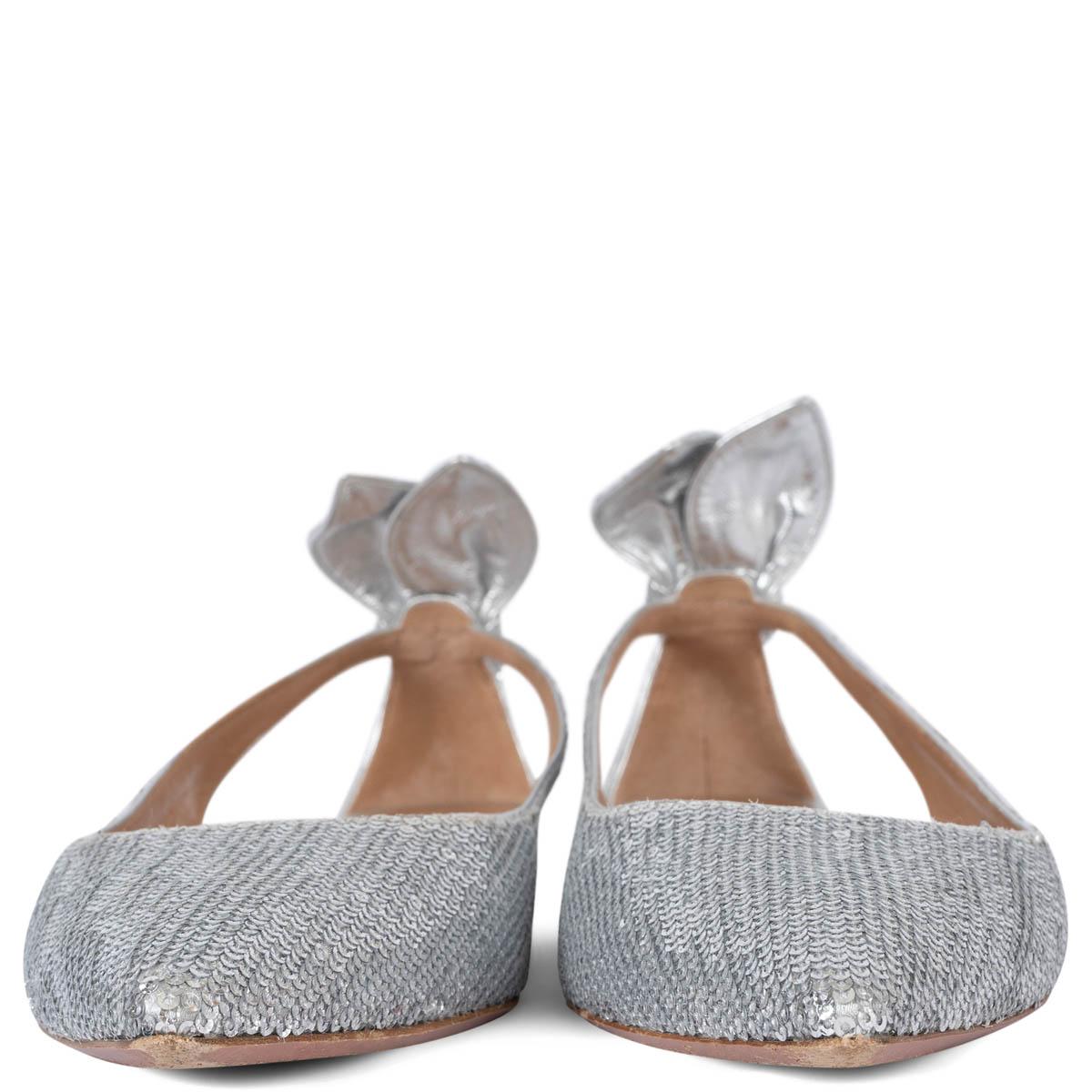 100% authentic Aquazzura Bow Tie ballet flats are crafted from silver-tone sequins featuring polished silver heel, pointed-toe and cut-out detailing with tie-knots at the heel counter. Have been worn and are in excellent condition.
