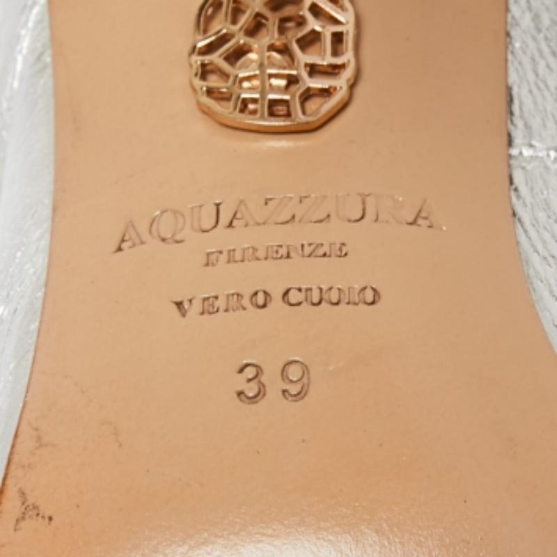 Aquazzura brings forth an amazing style in the form of these sandals that add a bold finish to your ensemble. Designed from silver leather, these sandals, with cut-out details, ties, and 11.5 cm heels, are a great choice to rock a chic look.