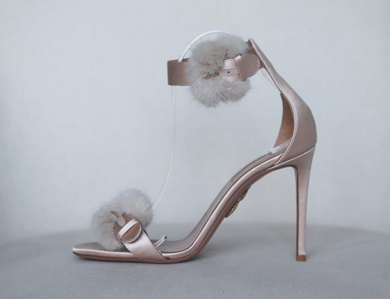 Aquazzura's sandals have been made in Italy from nude mink fur trim and satin, they're set on a subtle 105mm stiletto heel that's balanced by a concealed cushioned toe silhouette and buckle fastening. Heel measures approximately 105mm/ 4 inches.