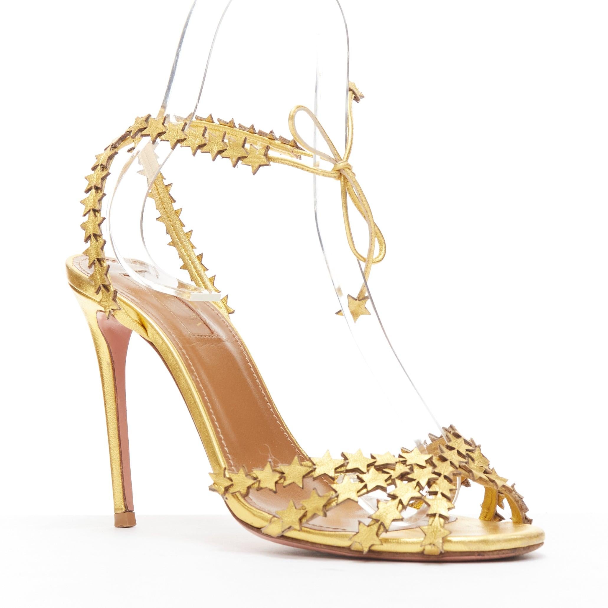 AQUAZZURA Starlight 105 gold leather star cutout strappy sandal heel EU36.5
Reference: JACG/A00152
Brand: Aquazzura
Model: Starlight 105
Material: Leather
Color: Gold
Pattern: Solid
Closure: Ankle Strap
Lining: Brown Leather
Extra Details: Star