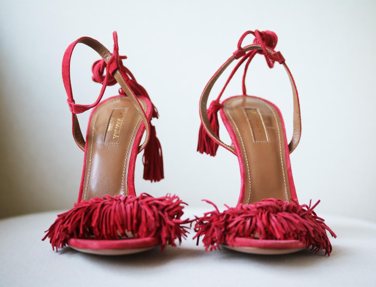 Aquazzura's 'lipstick' red 'Wild Thing' sandals will make a bold addition to your evening wardrobe. They're impeccably crafted from suede and detailed with playful fringing and tasseled ankle ties. Heel measures approximately 105mm/ 4 inches. Red