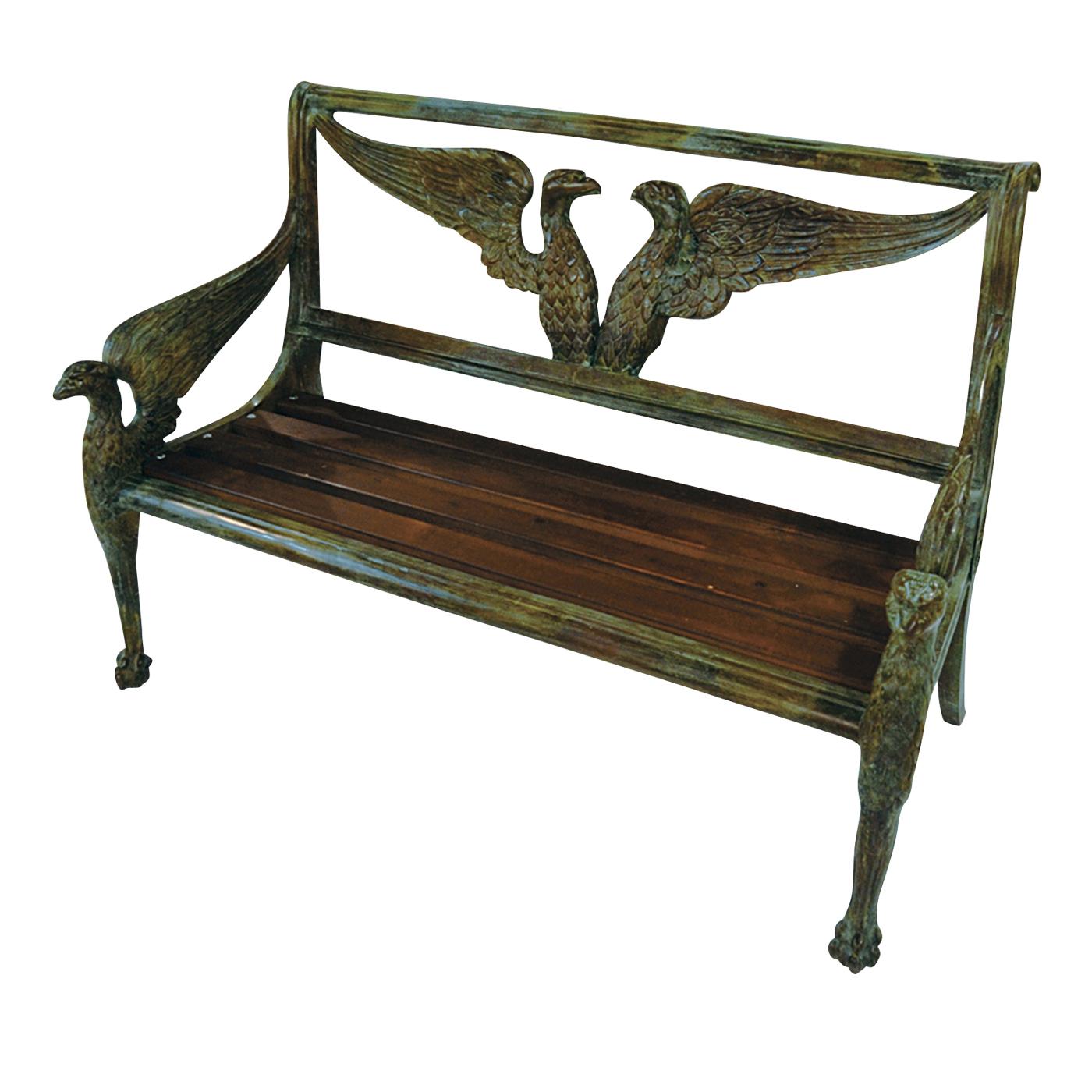 This exquisite bench features a seat in wood and a structure magnificently executed in bronze using the lost-wax technique. The two front legs are in the shape of an eagle portrayed in profile with its wings spread backwards to form the armrests.