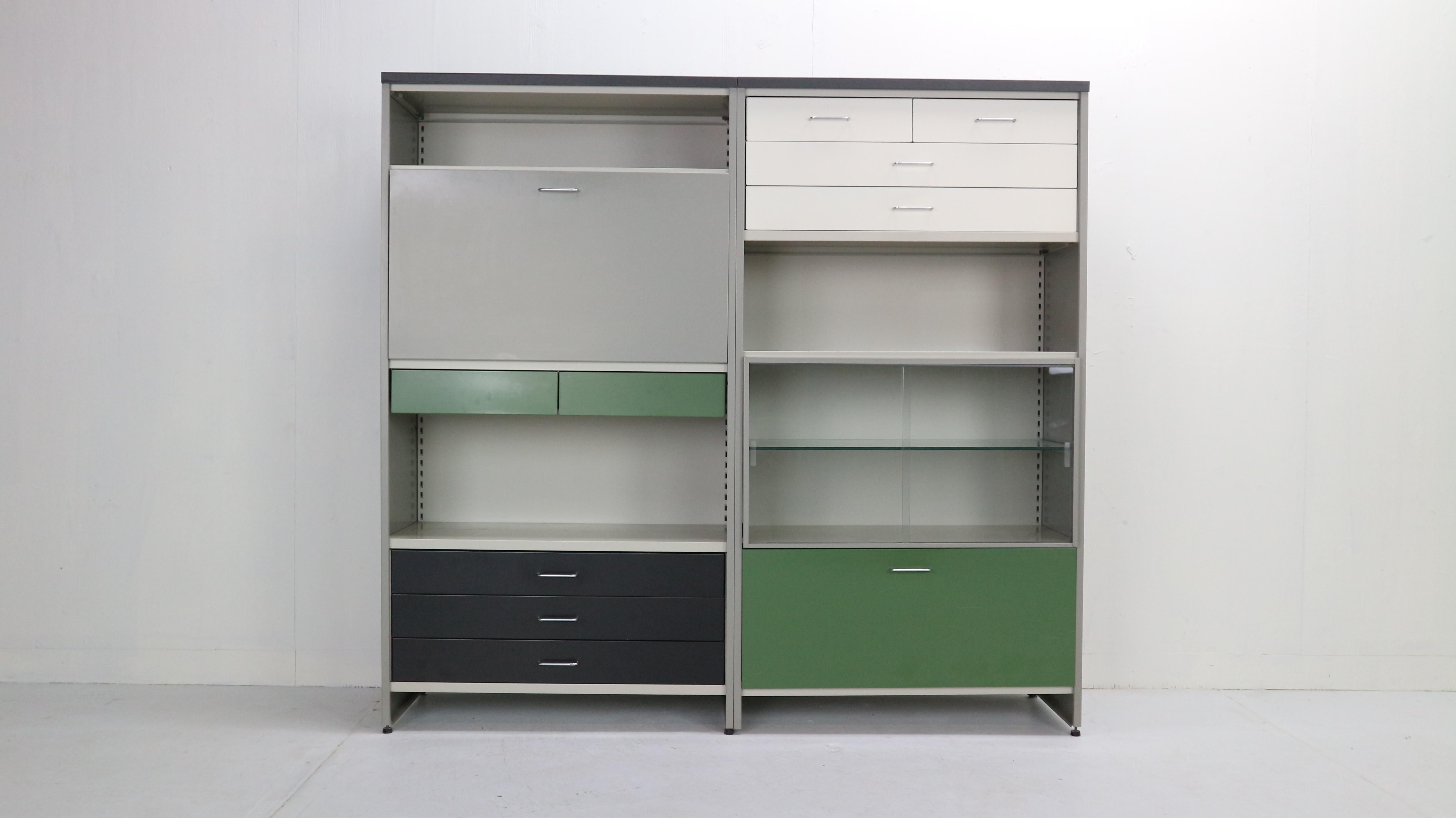 This colorful industrial cabinet was designed in 1962 by Dutch designers A.R. Cordemeijer& L. Holleman for Gispen, The Netherlands.
The cabinet consist with 10 drawers, storage space, glass cabinet, book shelving’s and drop down desk with