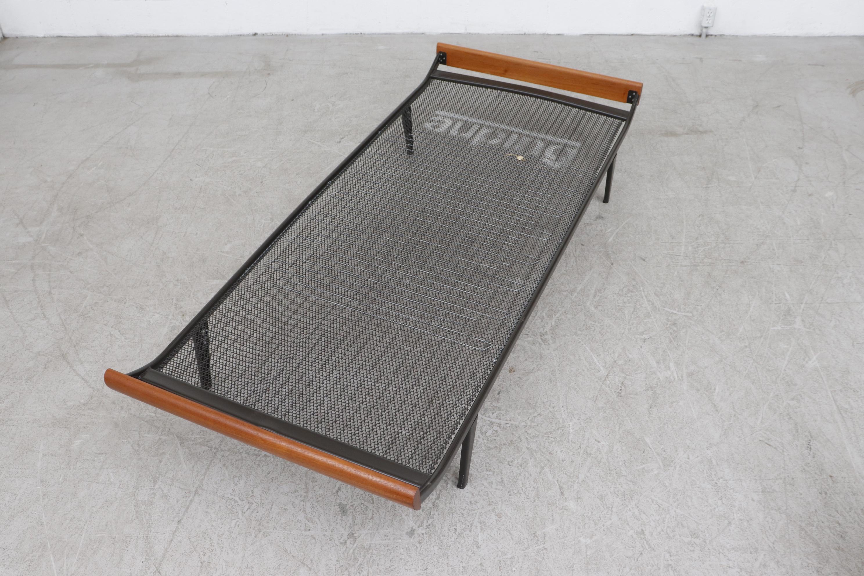 1960s Cleopatra daybed by A.R. Cordemeyer. With new indigo upholstered mattress, matching bolster, teak ends and dark brown enameled metal frame with 